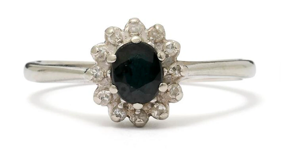 A sapphire- and diamond ring set with a sapphire and diamonds, mounted