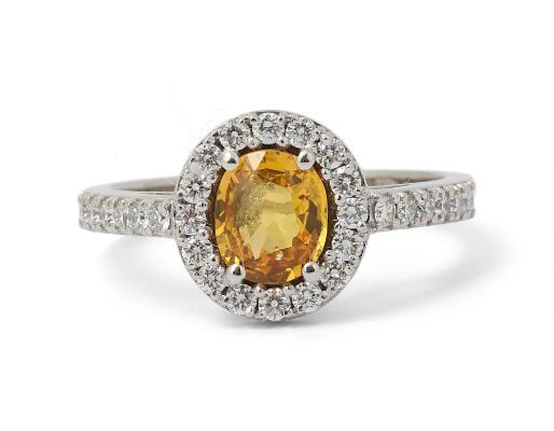 A sapphire and diamond ring set with a yellow sapphire and diamonds