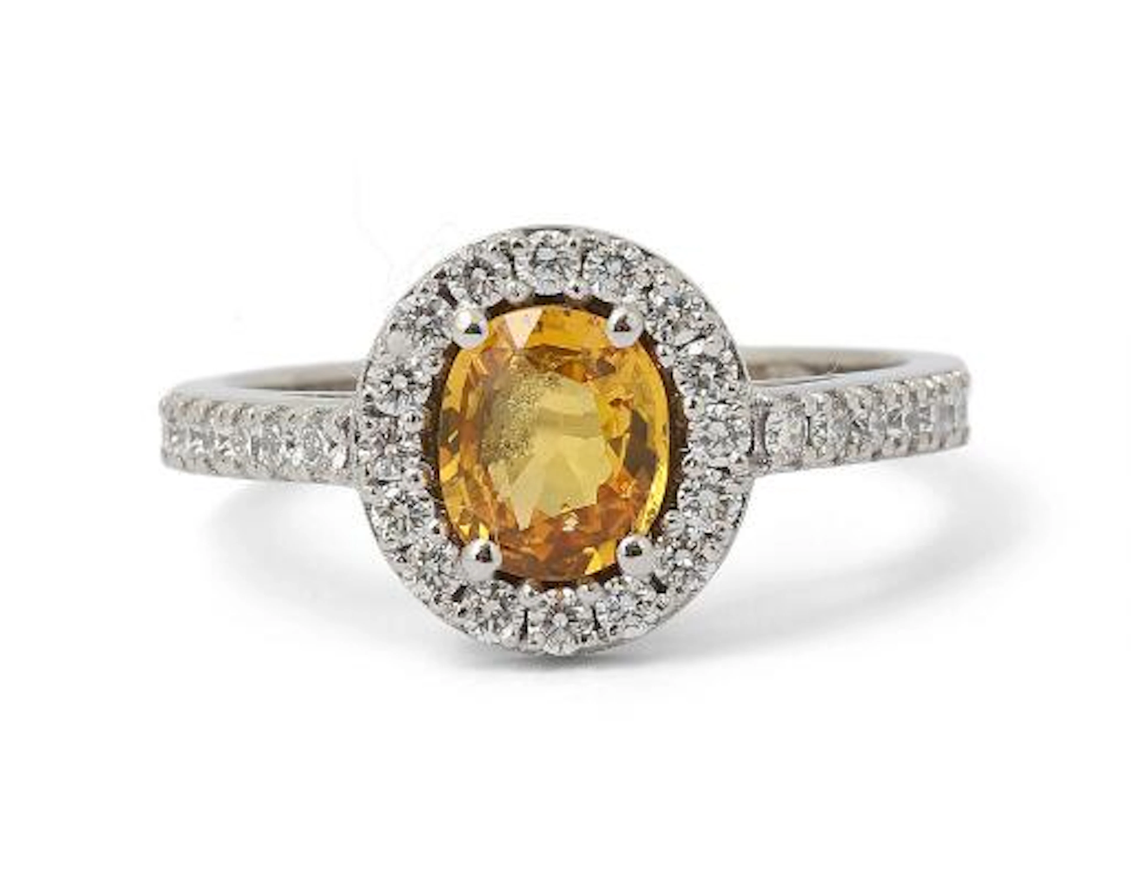 A sapphire and diamond ring set with a yellow sapphire and diamonds