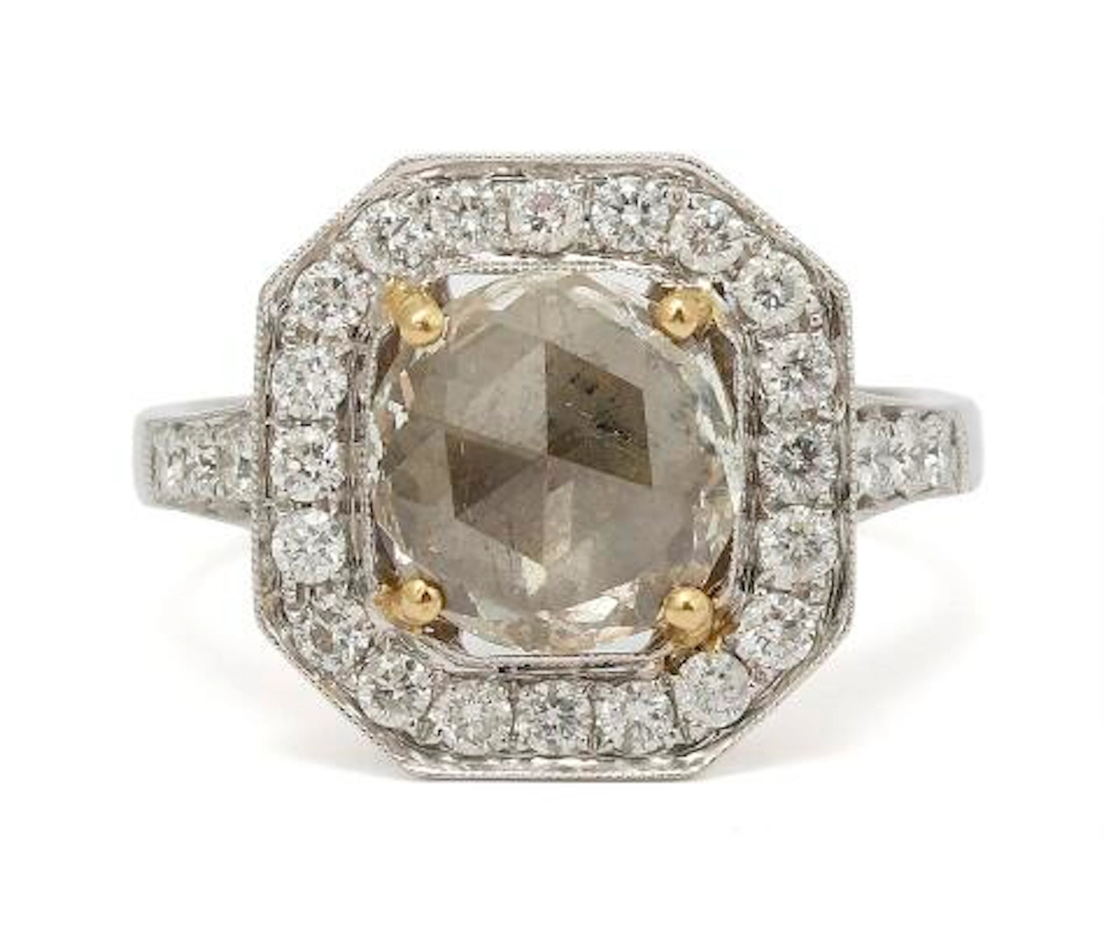 A diamond ring set with a rose-cut diamond encircled by diamonds