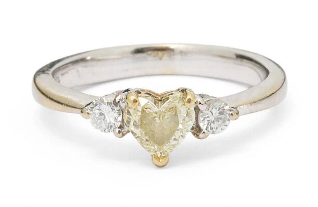 Hartmann's: A diamond ring set with a fancy yellow heart-shaped diamond