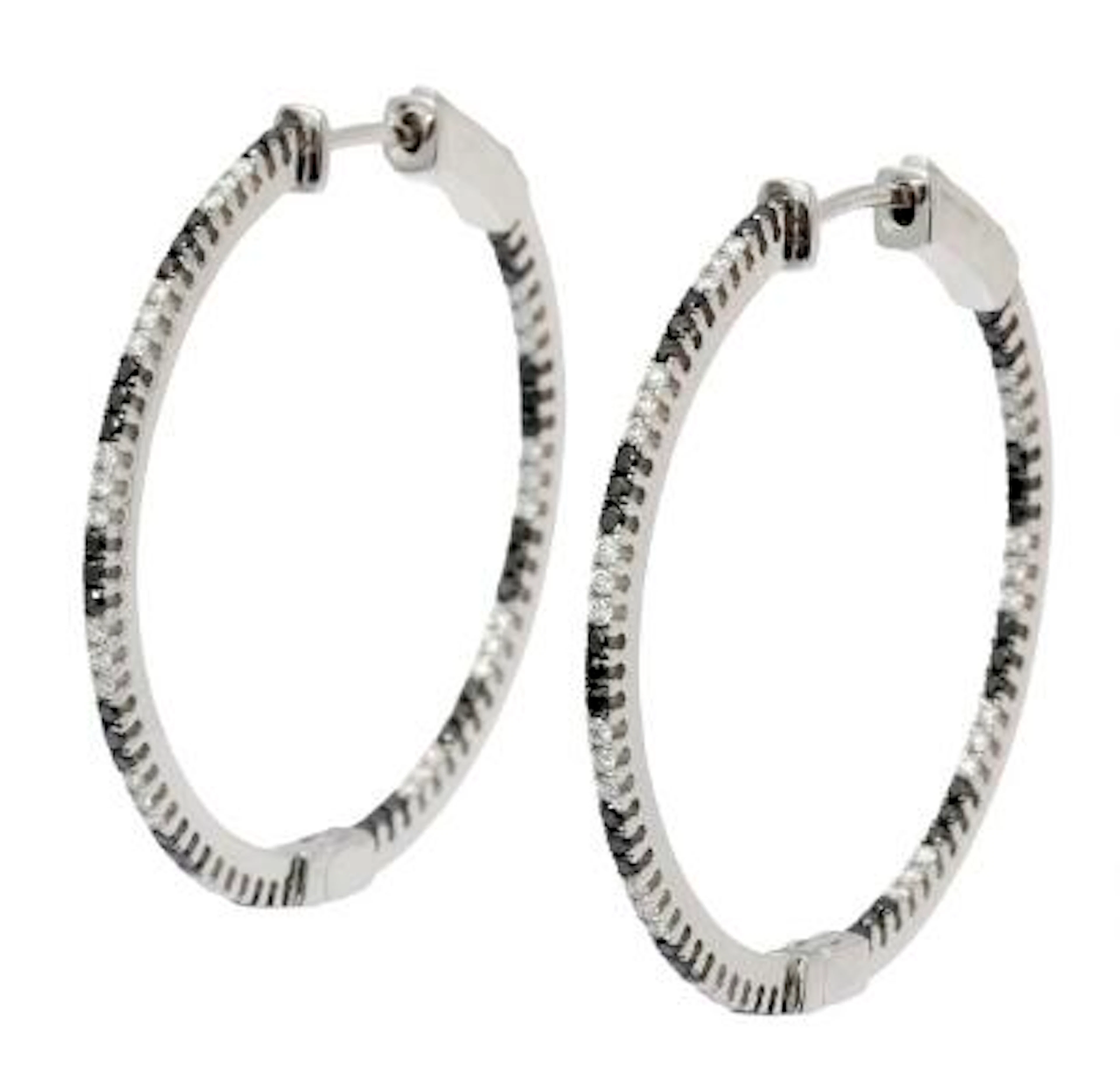 A pair of diamond ear studs set with numerous diamonds and black diamonds