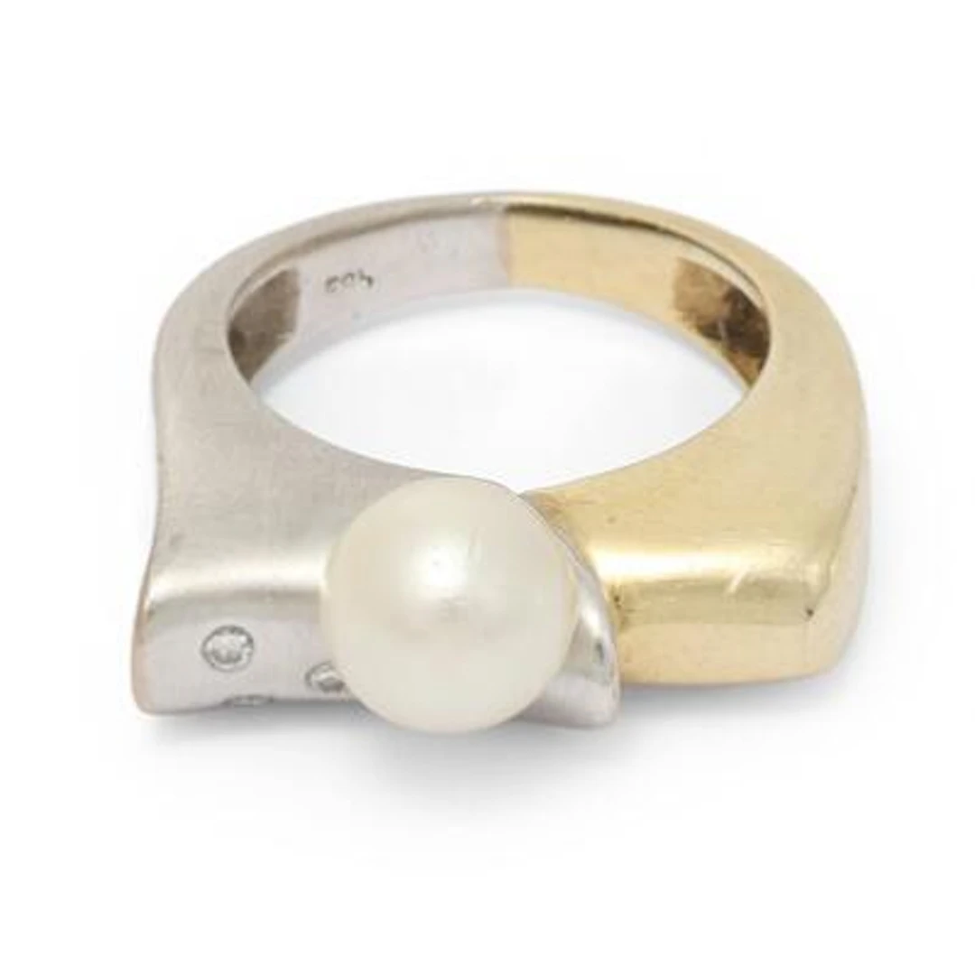 A pearl and diamond ring set with a pearl and diamonds mounted 14k