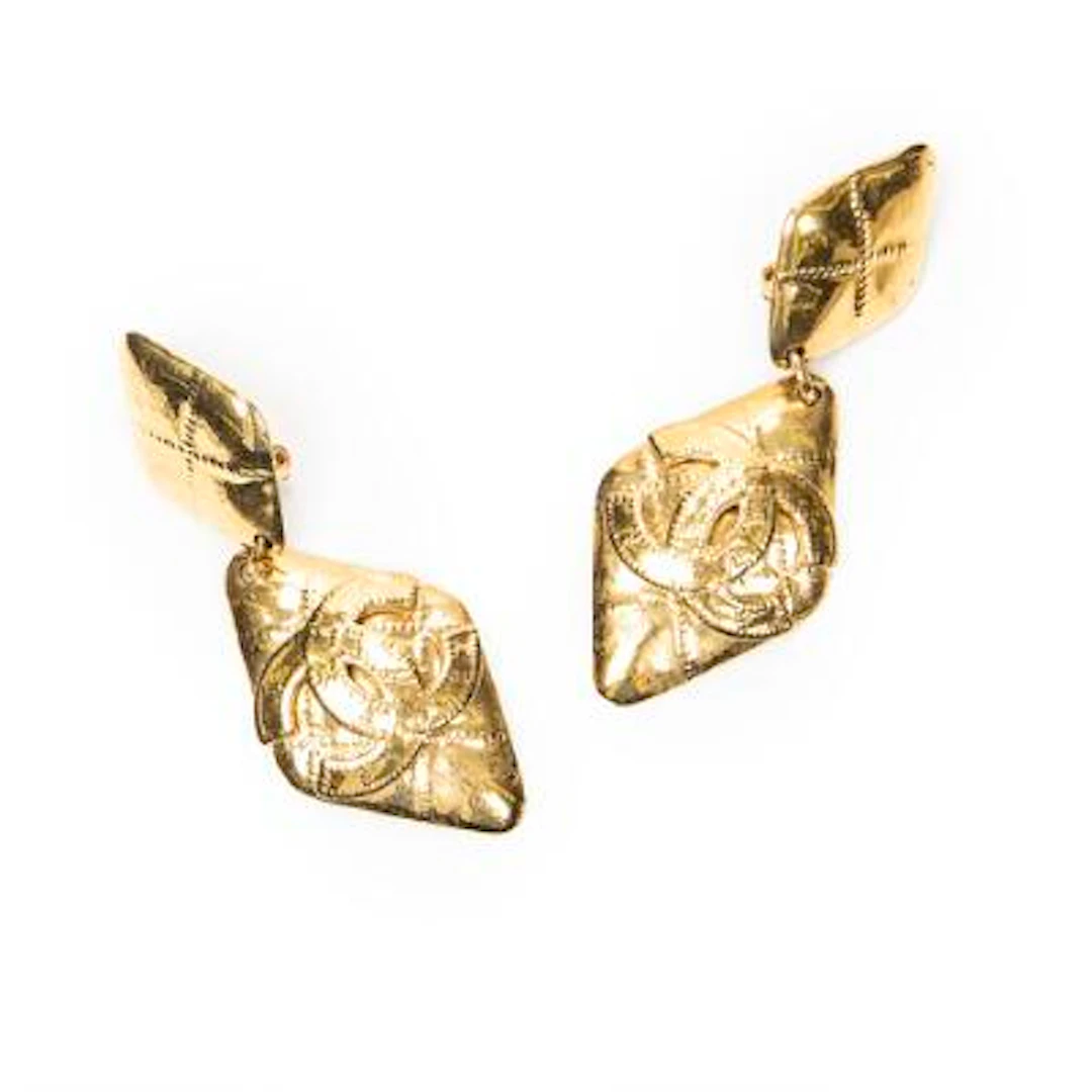 Chanel: A pair of ear clips of gold-tone metal each set with CC logo.