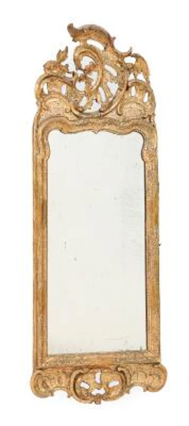 Rococo mirror of gilded wood and gesso, carved with rocailles, combs