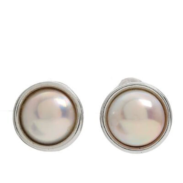Støvring: A pair of mabé pearl ear clips, each set with a mabé pearl
