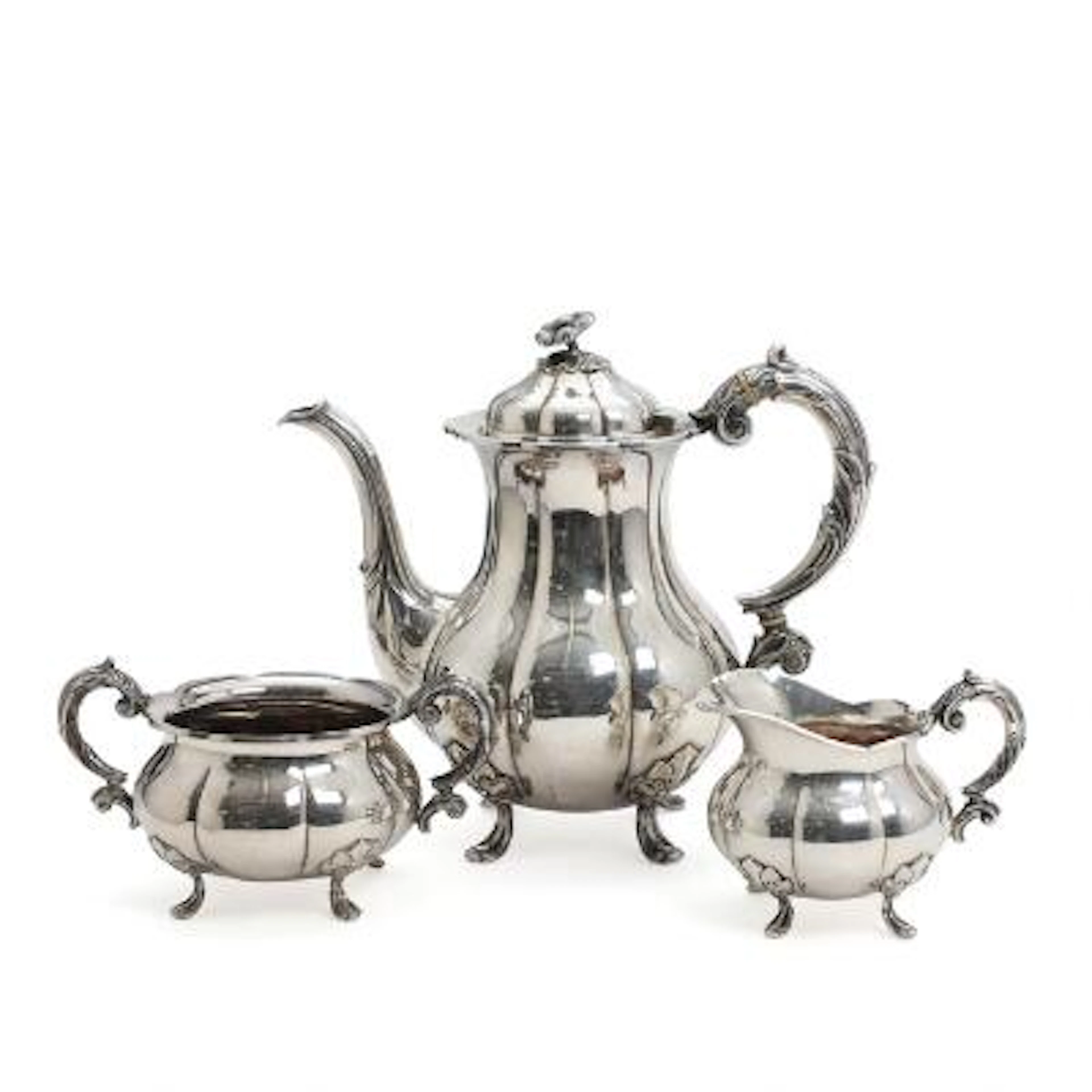 Silver coffee service comprising coffee pot, cream jug and sugar bowl.