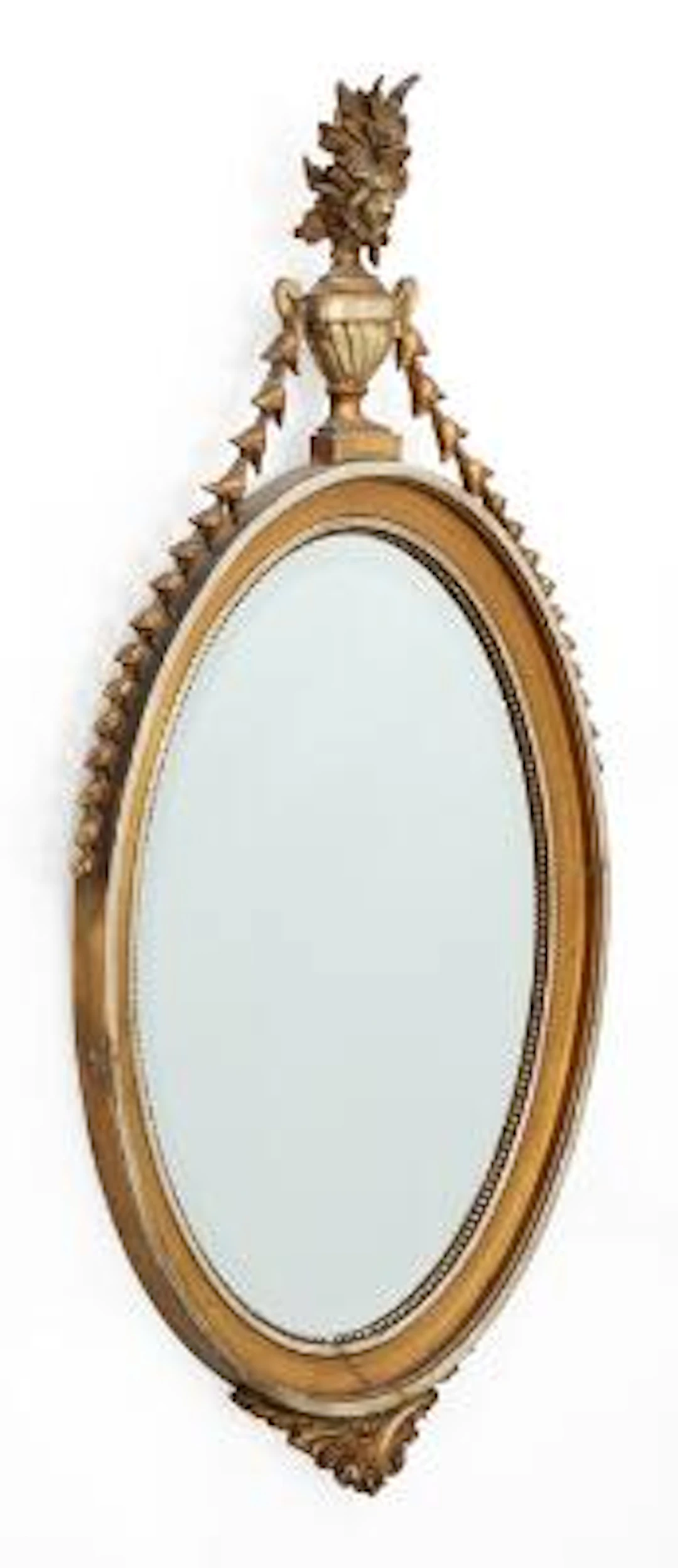 A large oval mirror in frame of gilt and silvered wood in the style