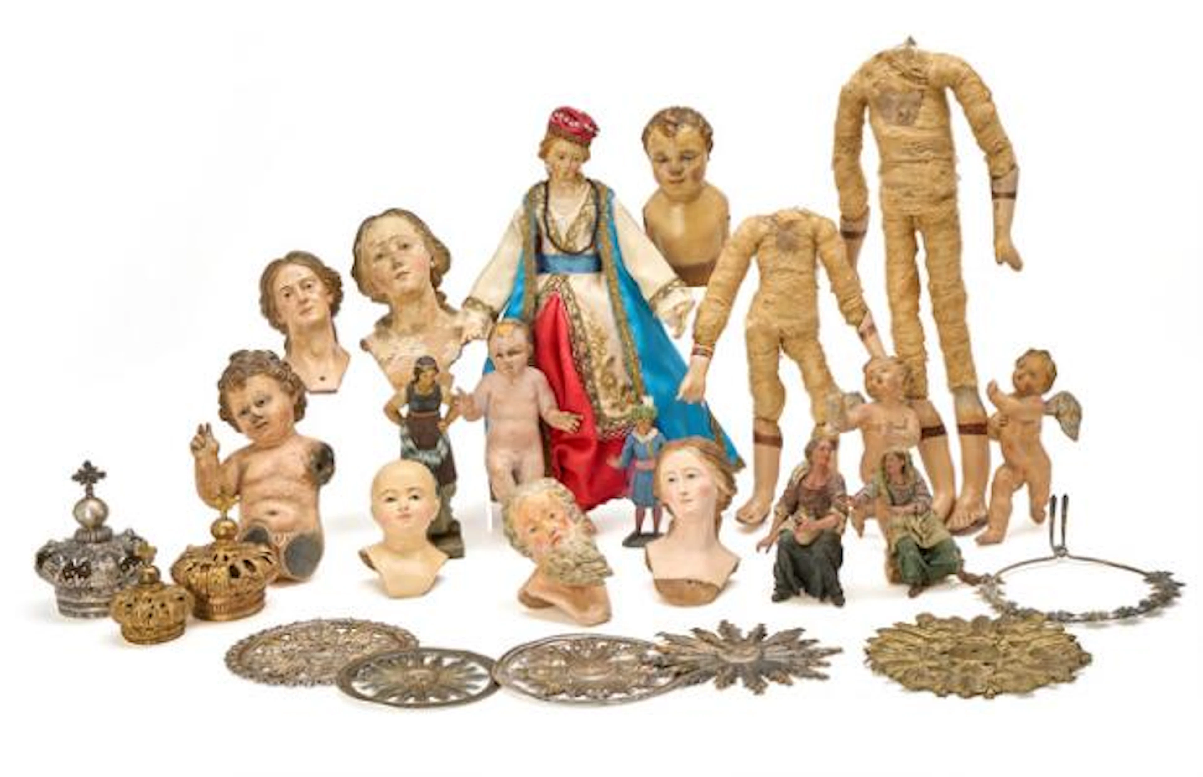 A collection of fragmented and individual doll parts and other accessories
