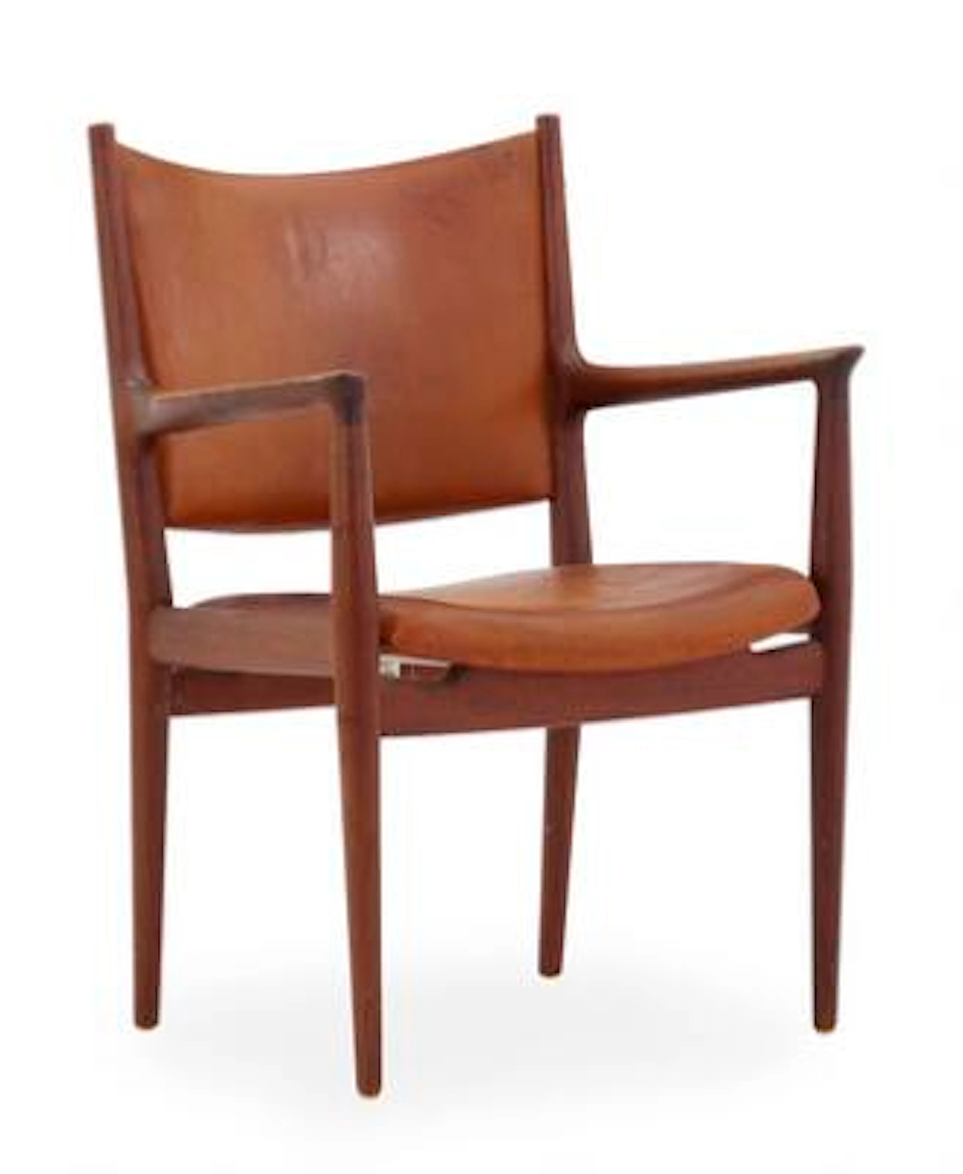 Hans J. Wegner: Armchair of teak. Seat and back upholstered with patinated