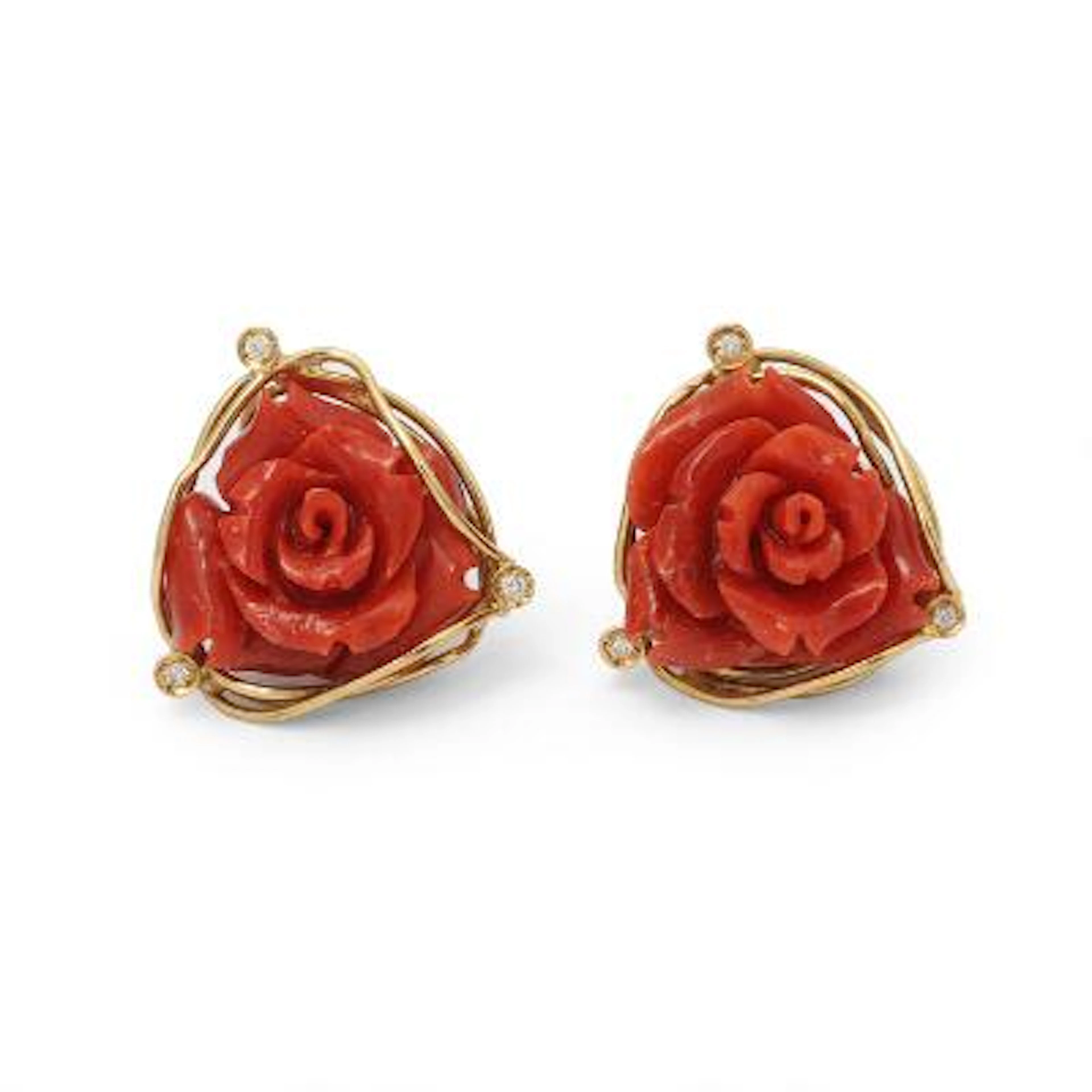 A pair of coral ear studs each set with carved coral, mounted in 18k