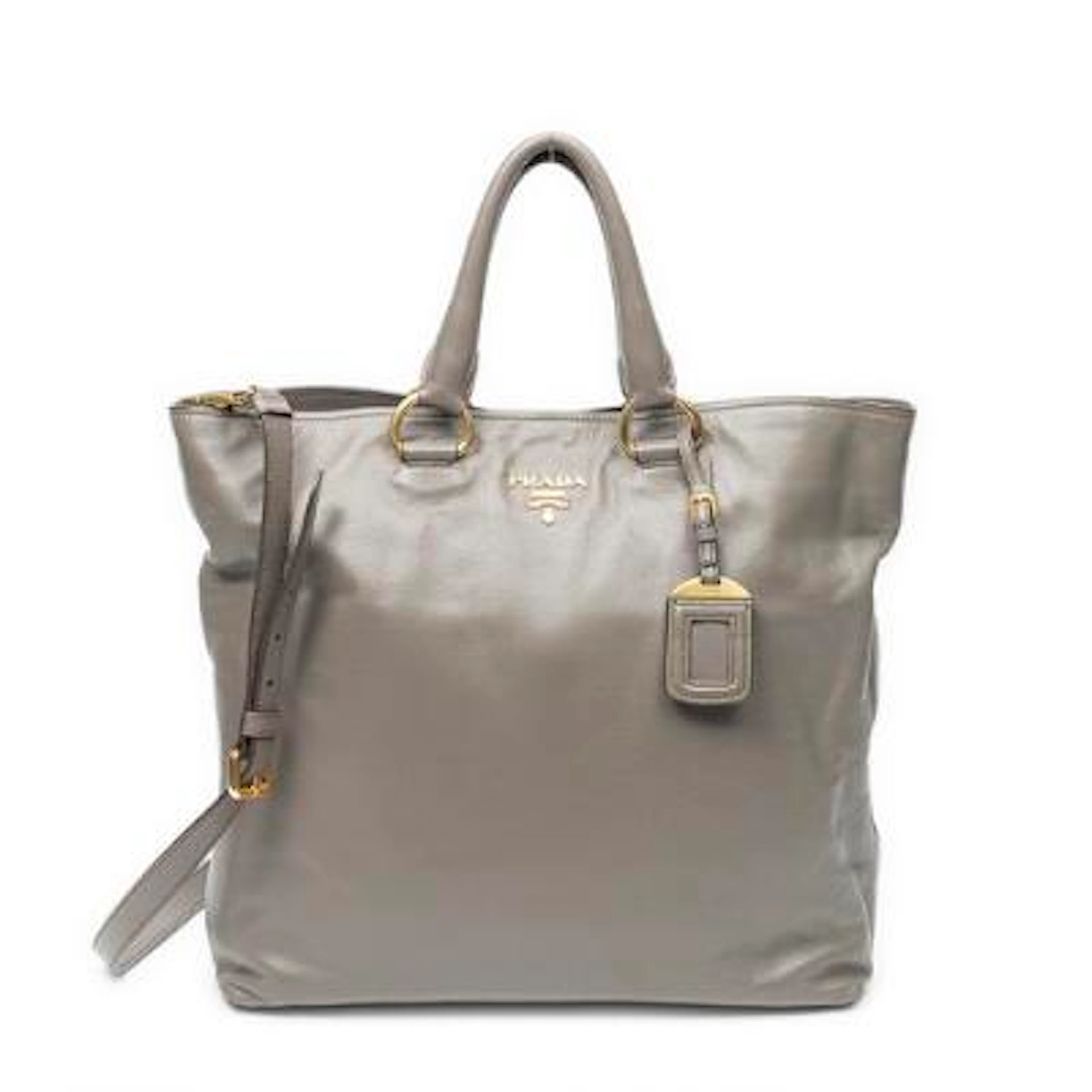 Prada: A "Convertible Shopping Tote" in taupe leather with two handles