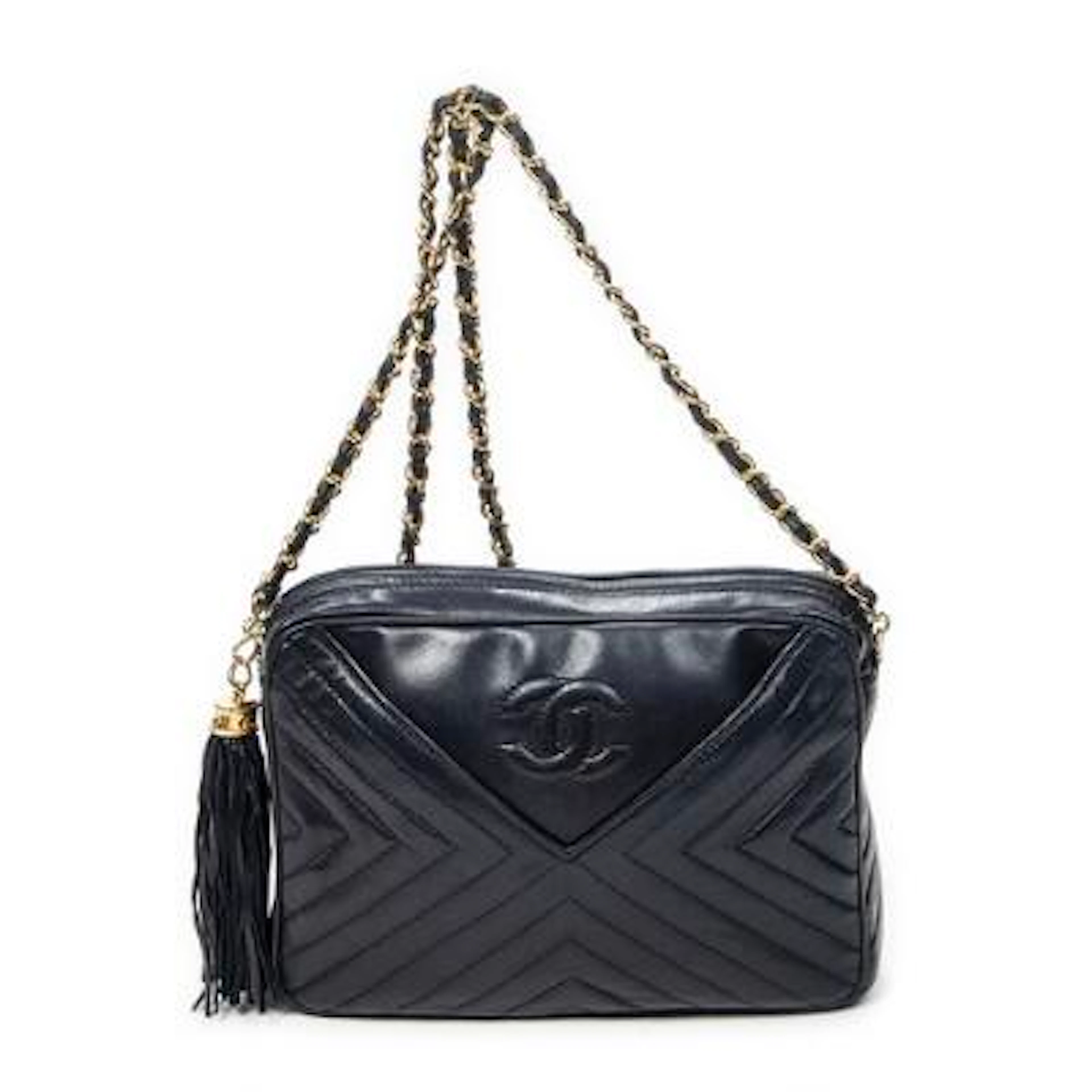 Chanel: A "CC Tassel Camera Bag" in navy blue quilted leather with