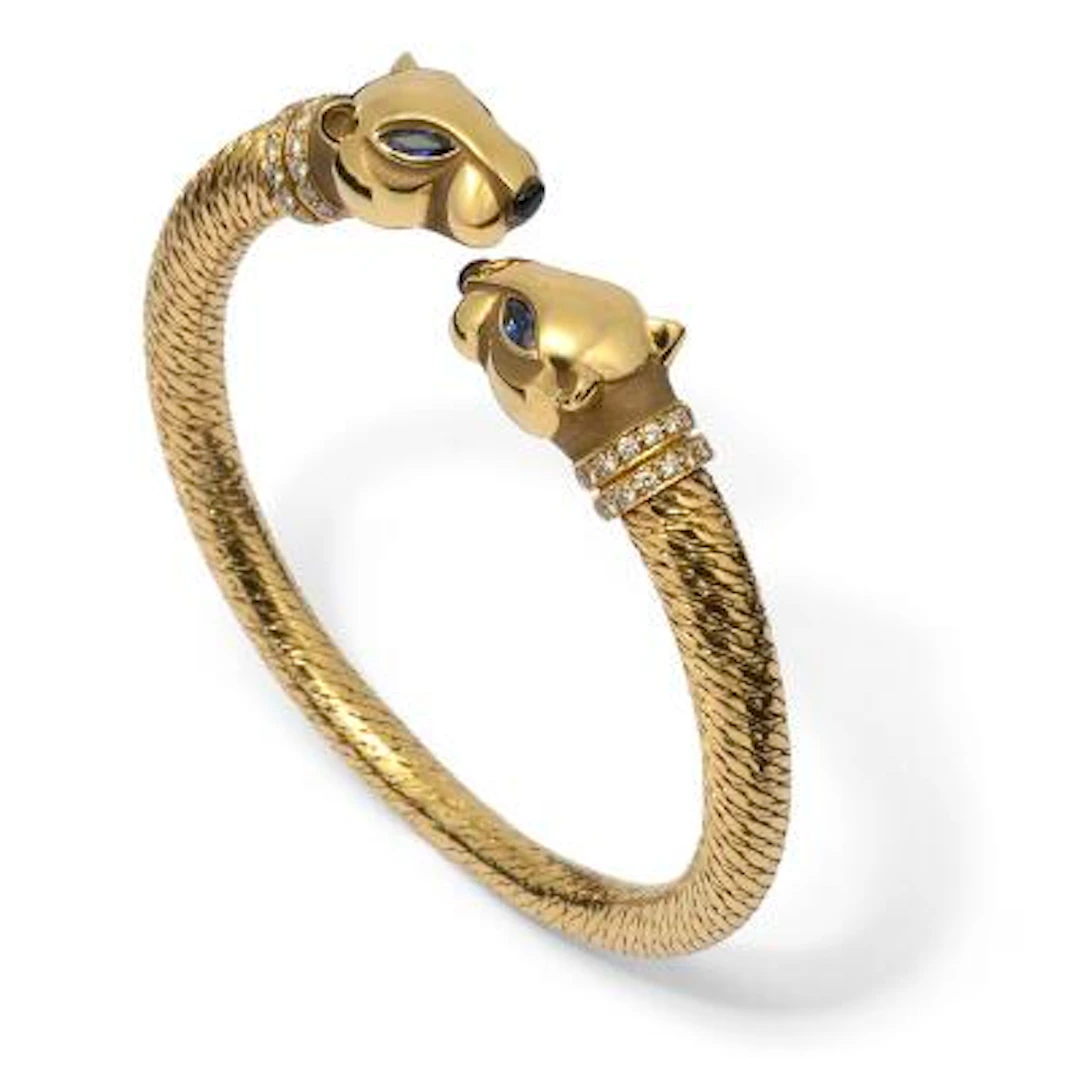 Cartier: A "Panthère" bangle set with sapphires and diamonds, mounted