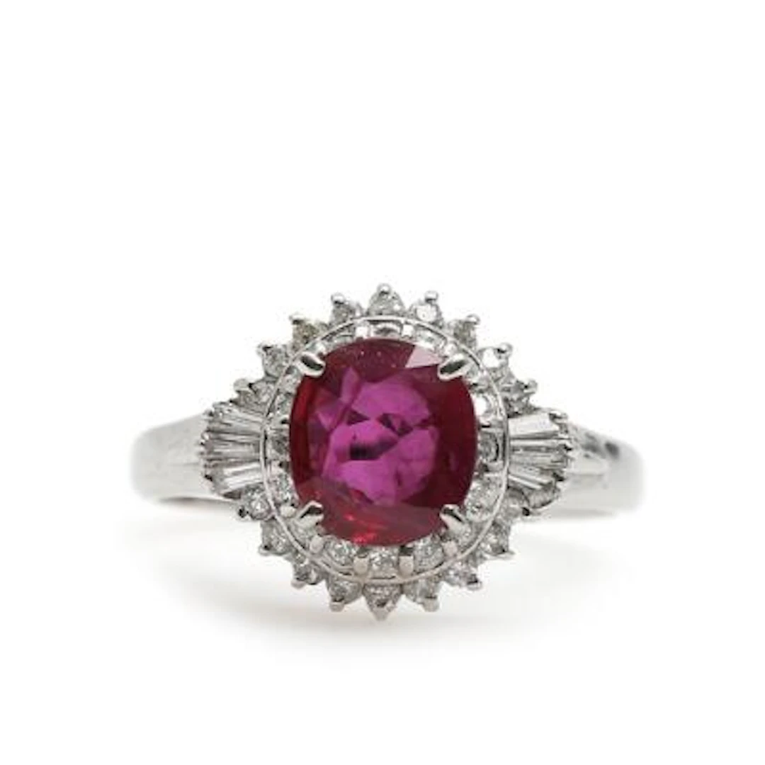 A ruby and diamond ring set with an oval-cut ruby and brilliant-cut