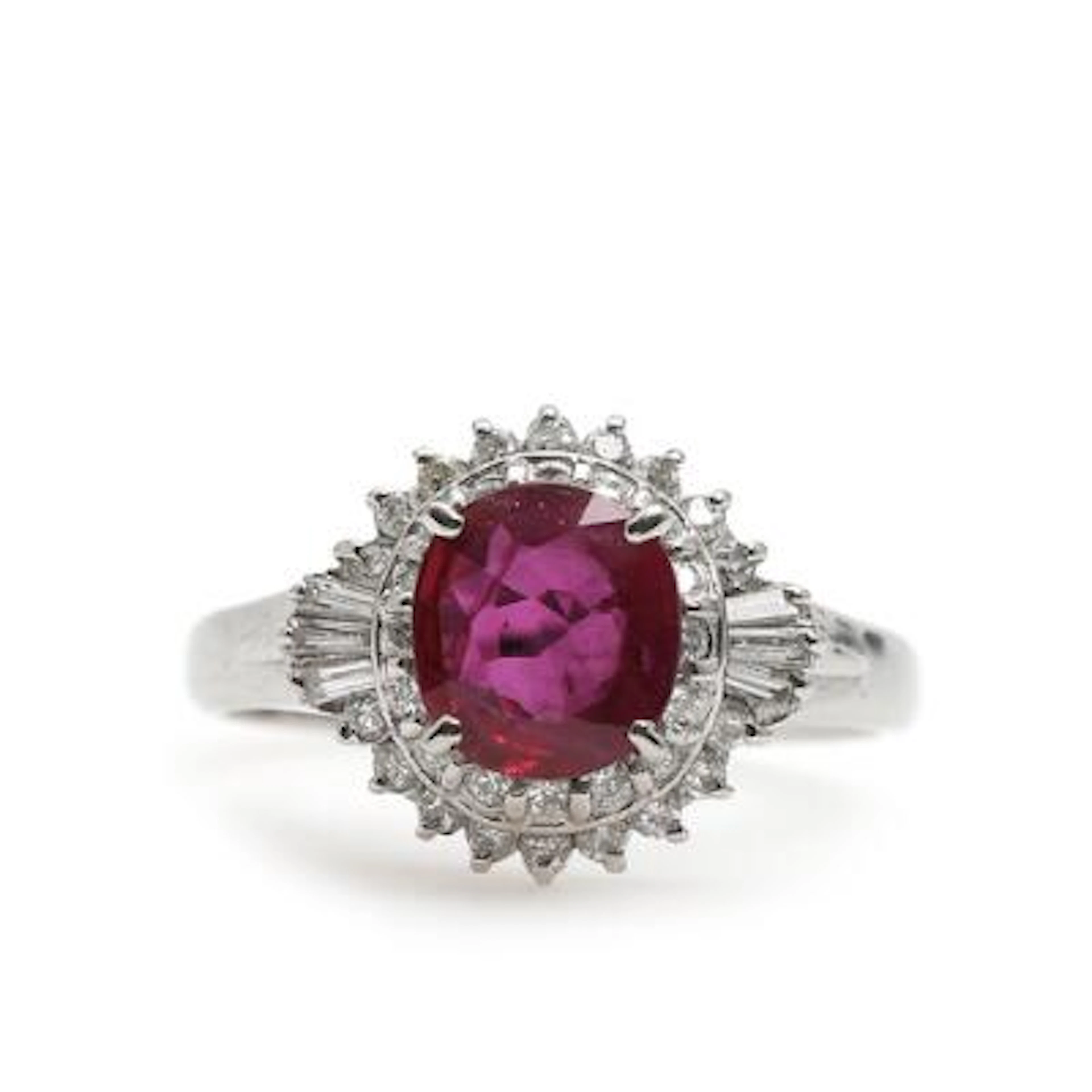 A ruby and diamond ring set with an oval-cut ruby and brilliant-cut