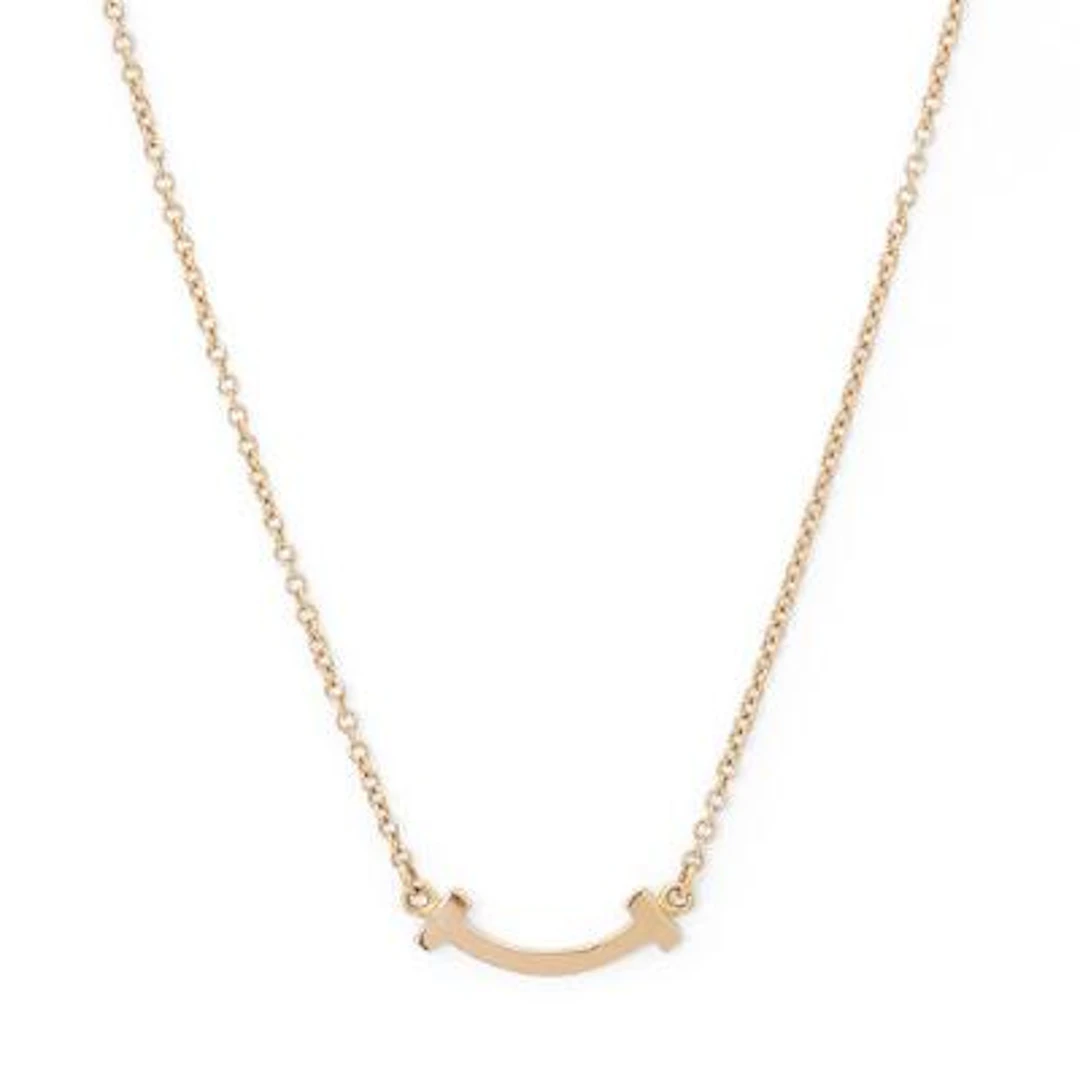Tiffany & Co.: A "T Smile" necklace of 18k rose gold. Weight app.