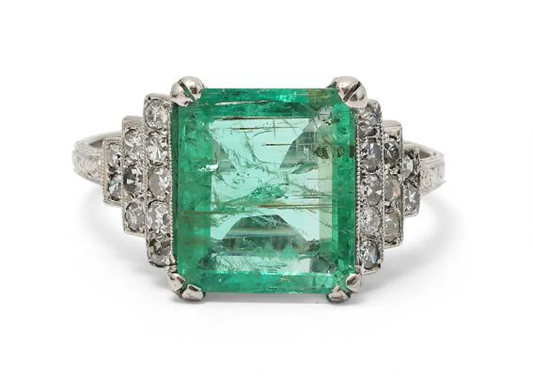 An Art Deco emerald and diamond ring set with an emerald and diamonds