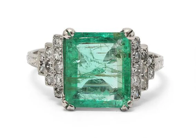An Art Deco emerald and diamond ring set with an emerald and diamonds