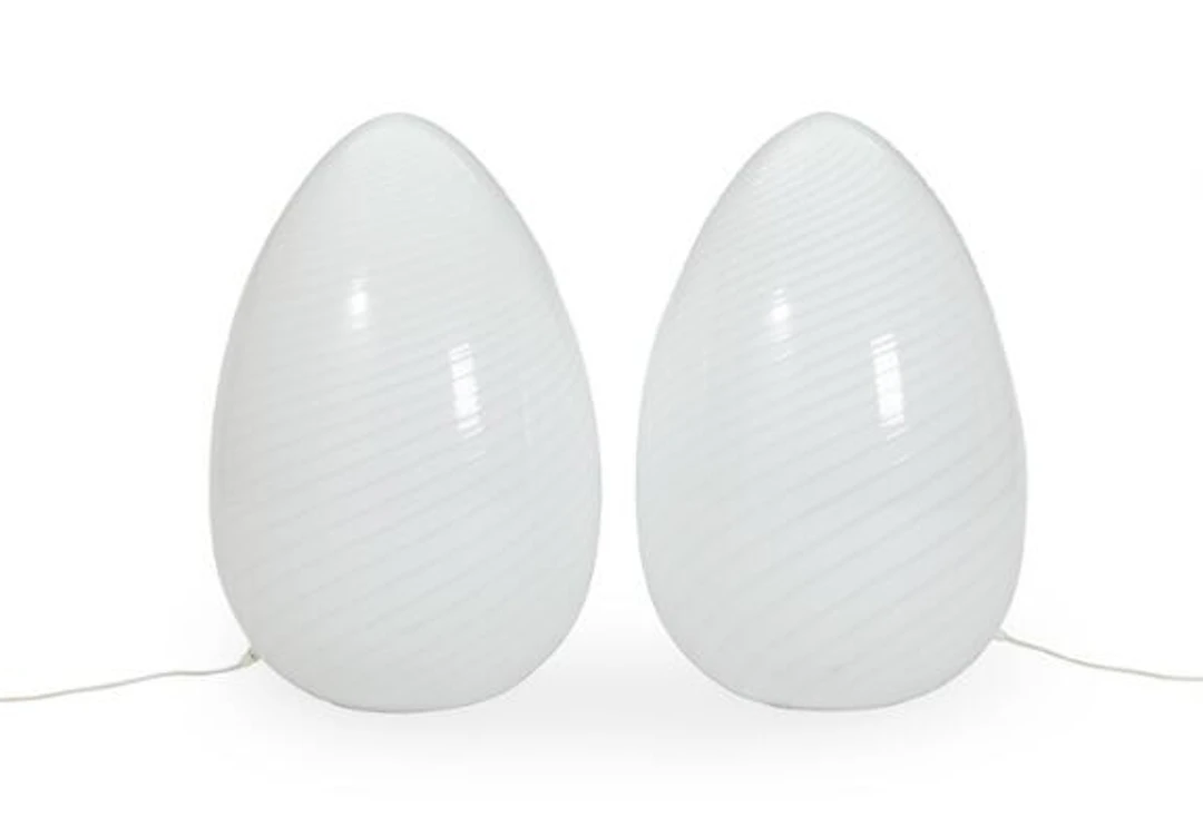 A pair of egg-shaped floor lamps in spiralform opal glass in rigadin