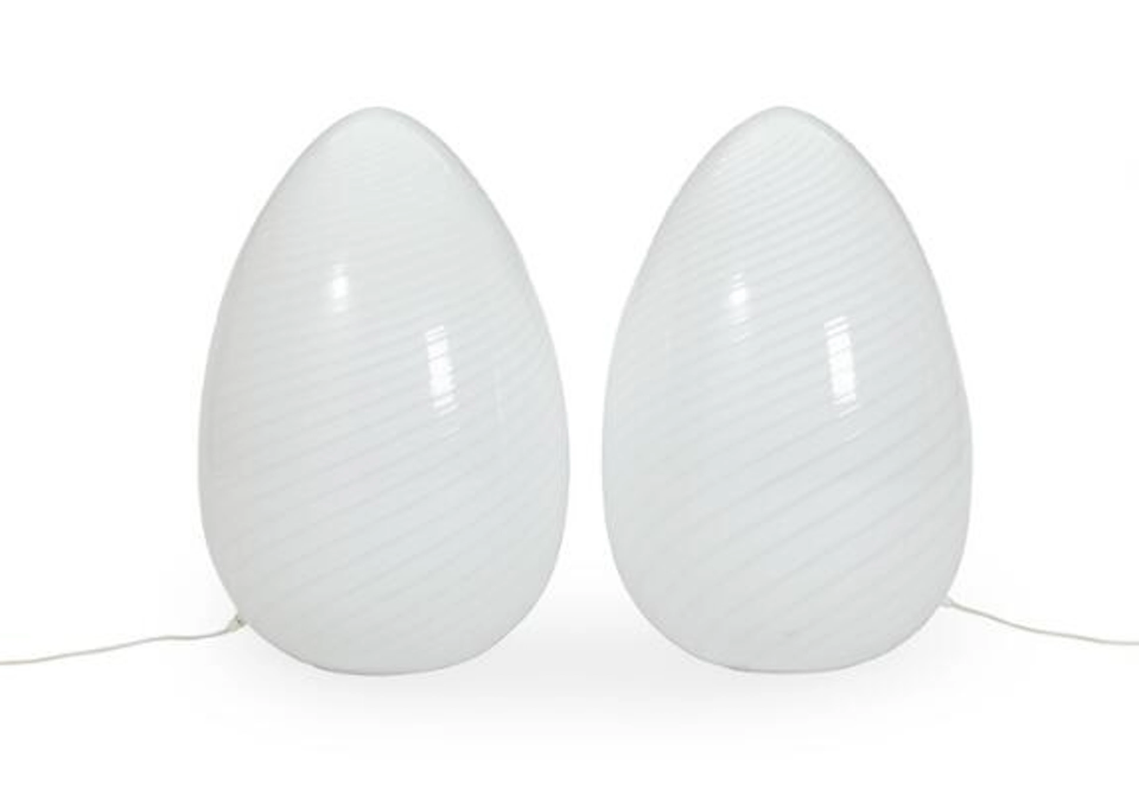 A pair of egg-shaped floor lamps in spiralform opal glass in rigadin