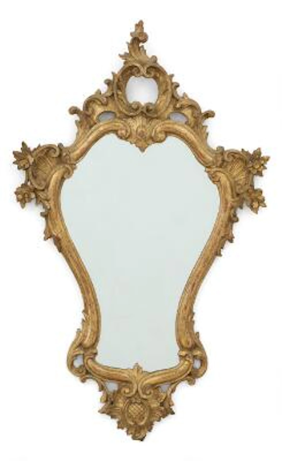 A French mirror in a gilded wood frame, carved with flowers and ornamentation.