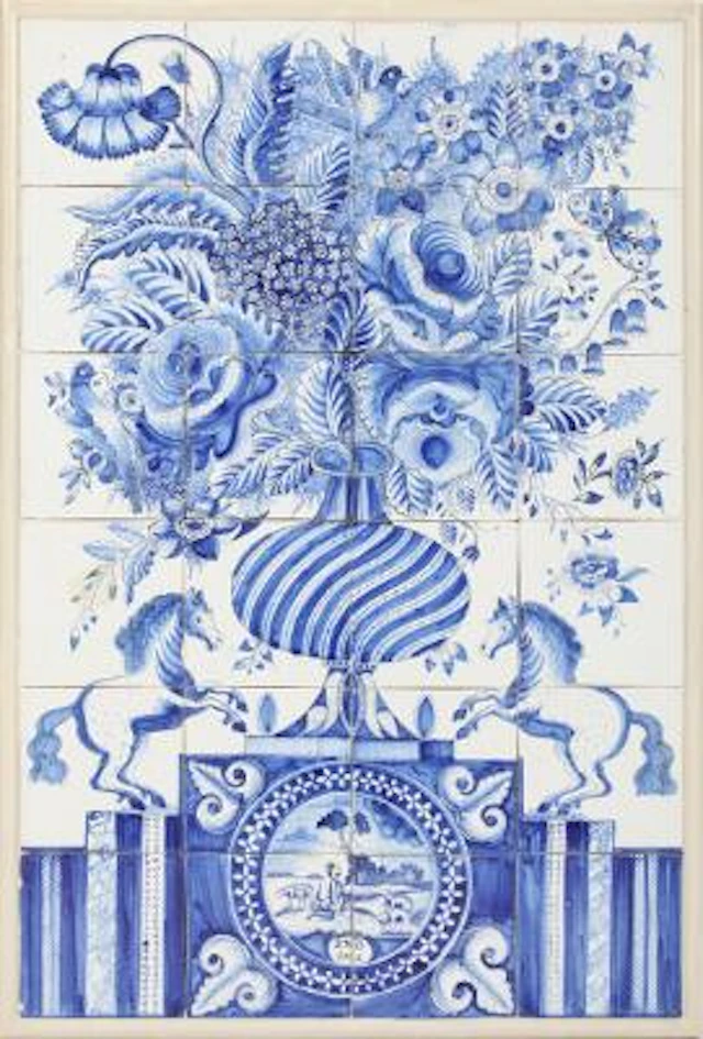 Delft tile picture of faience, decorated in blue with floral arrangement.