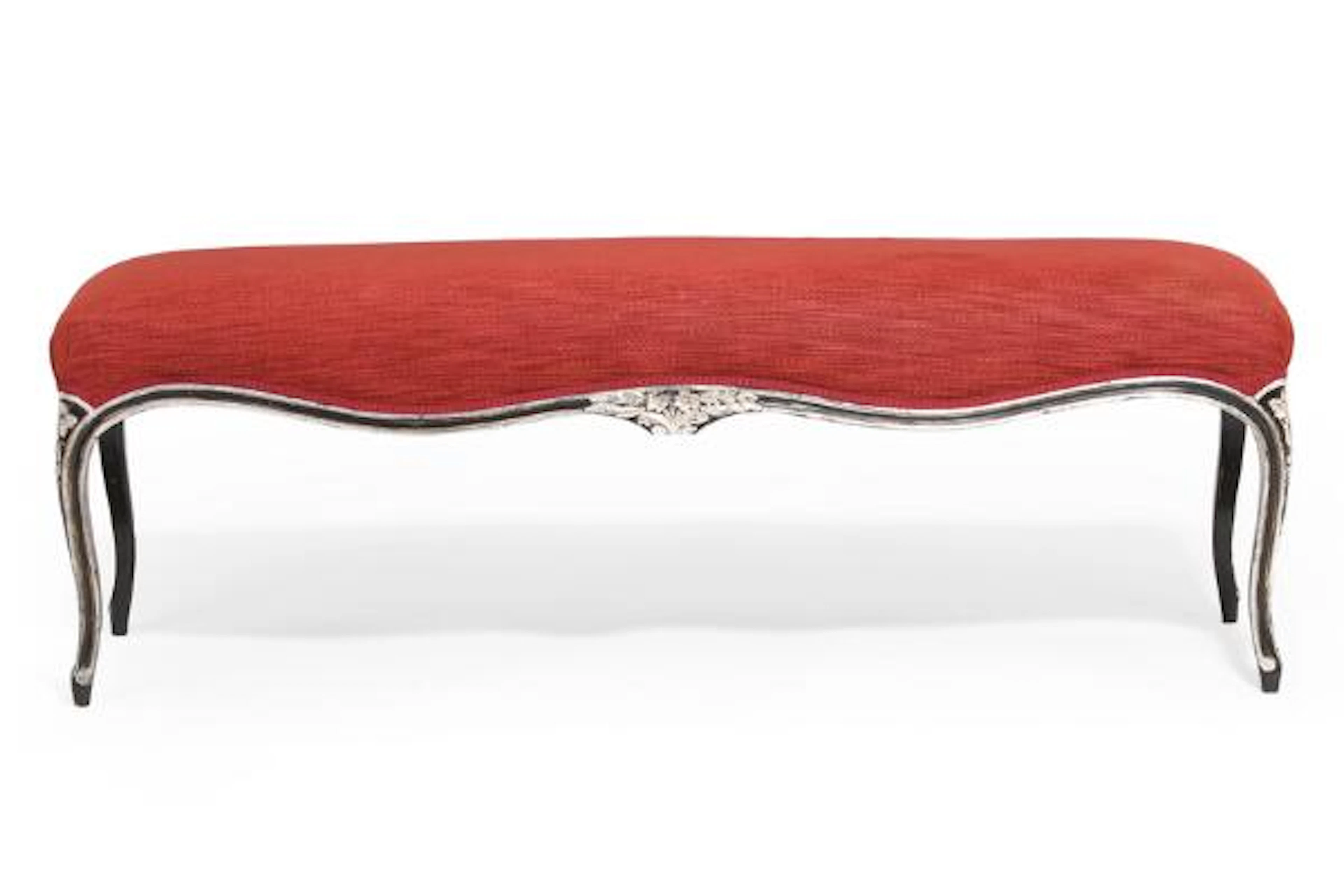 A Rococo style black painted and silvered freestanding wooden bench.