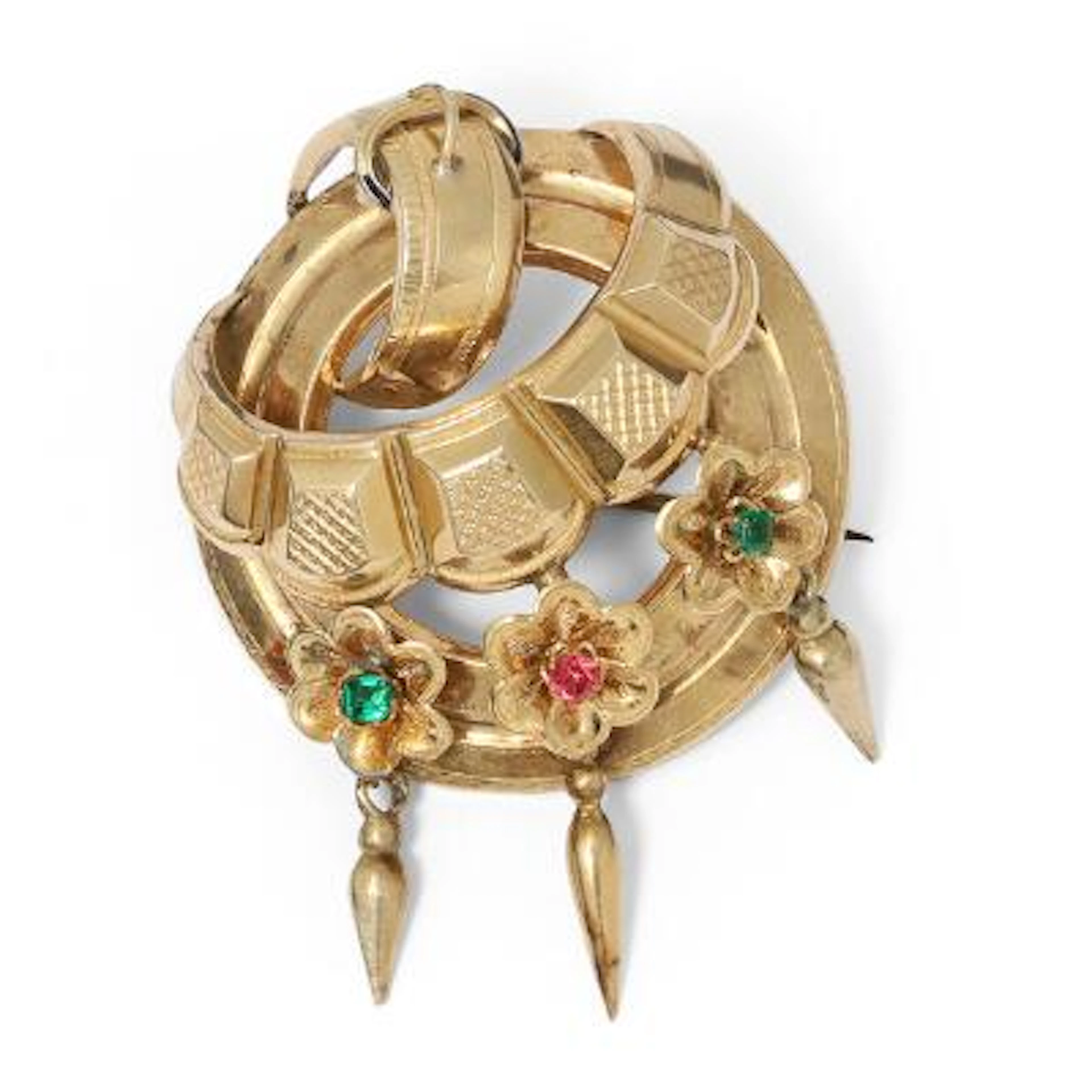 A brooch set with a pink tourmaline and green stones, mounted in 13k