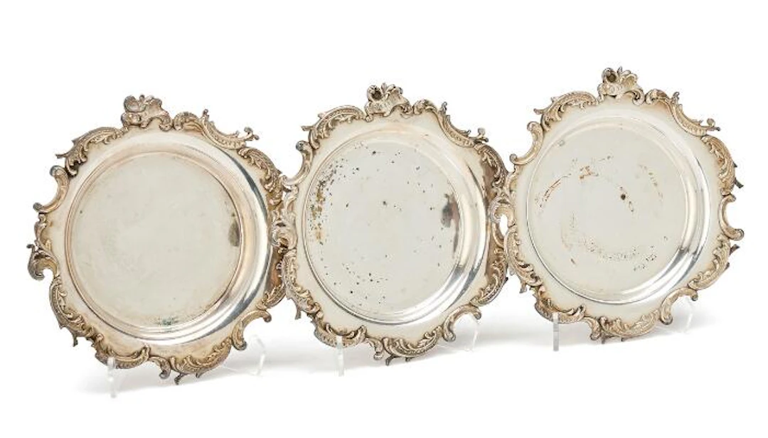 Three French silverplated wine coasters, Rococo style, late 19th century.