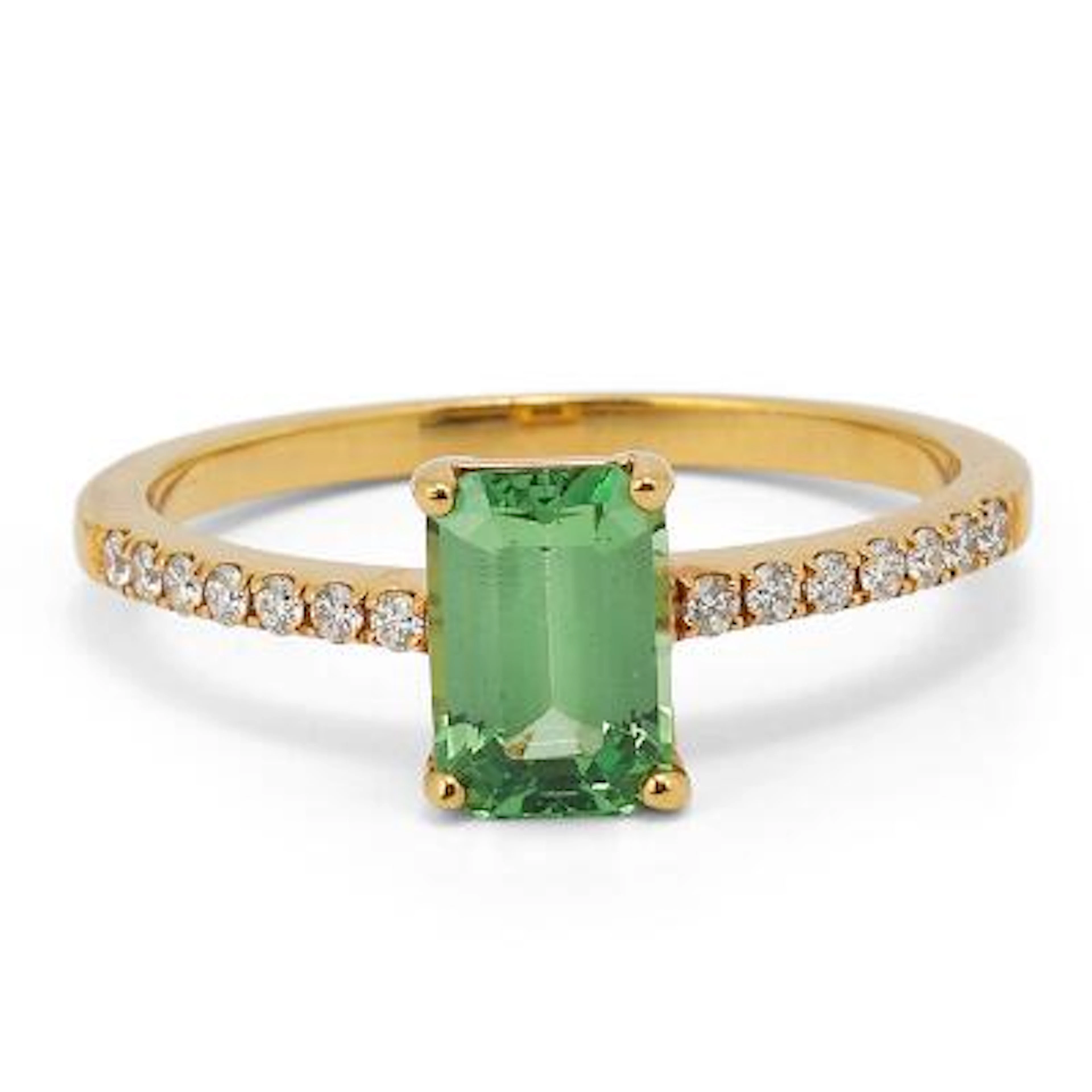 A tsavorite and diamond ring set with a tsavorite flanked by diamonds