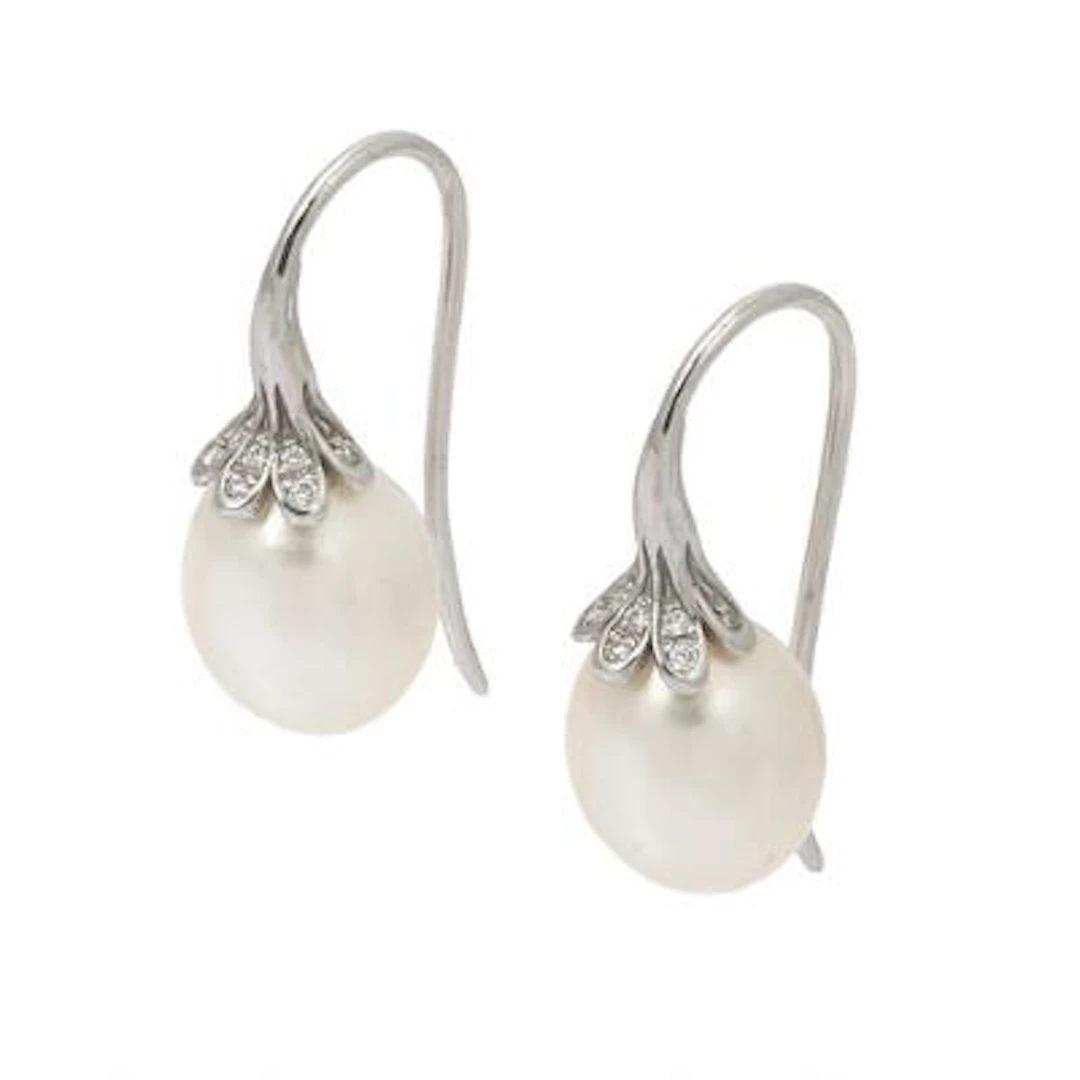 A pair of pearl and diamond ear studs each set with freshwater pearls