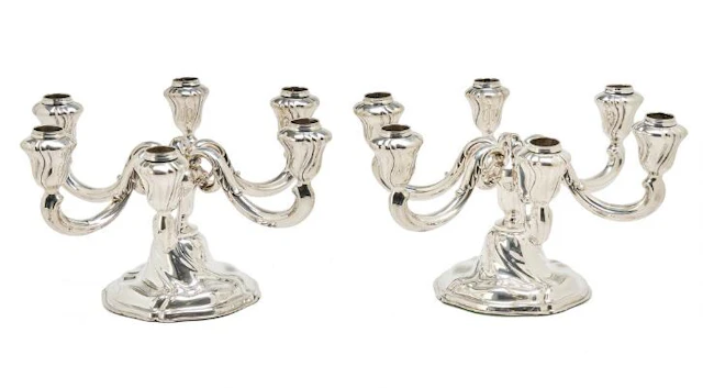 A pair of silver candelabra, each with six curved light arms. 835S.