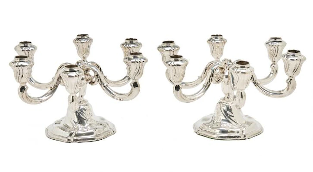 A pair of silver candelabra, each with six curved light arms. 835S.