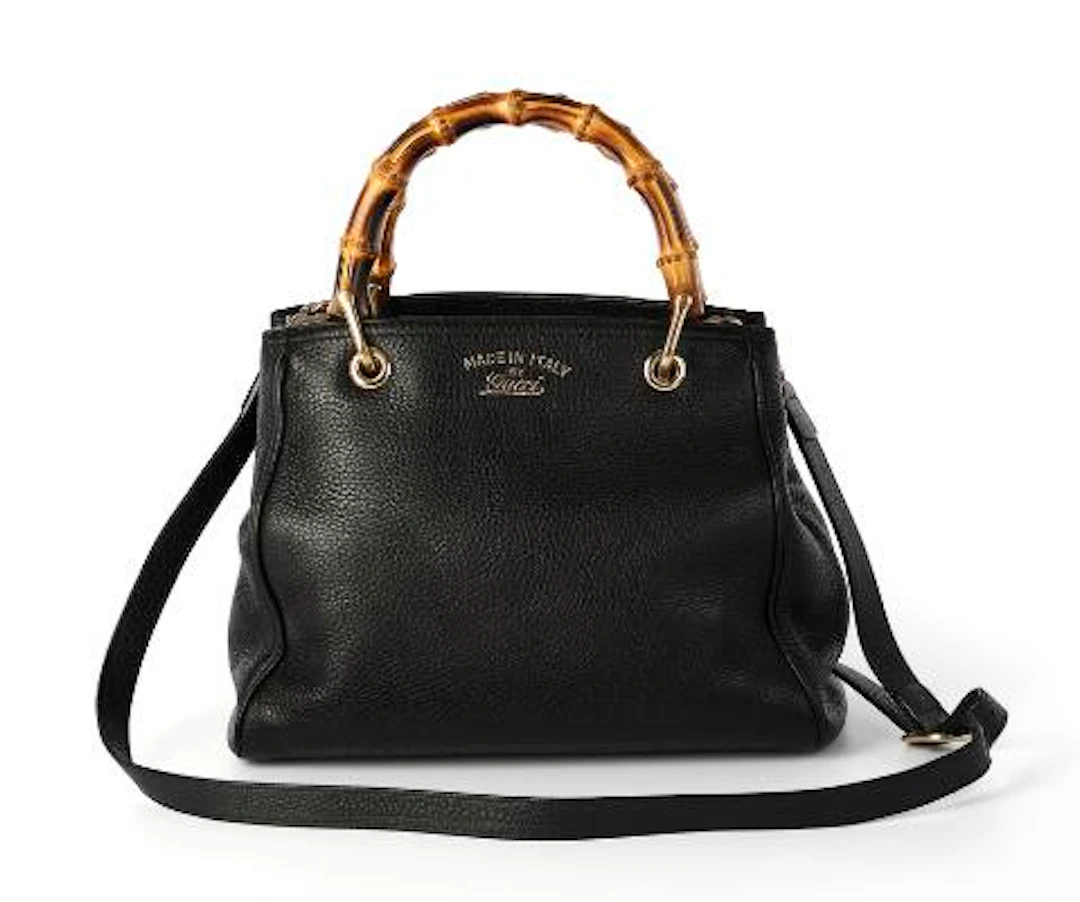 Gucci: A bag of black leather with gold tone hardware, two bamboo