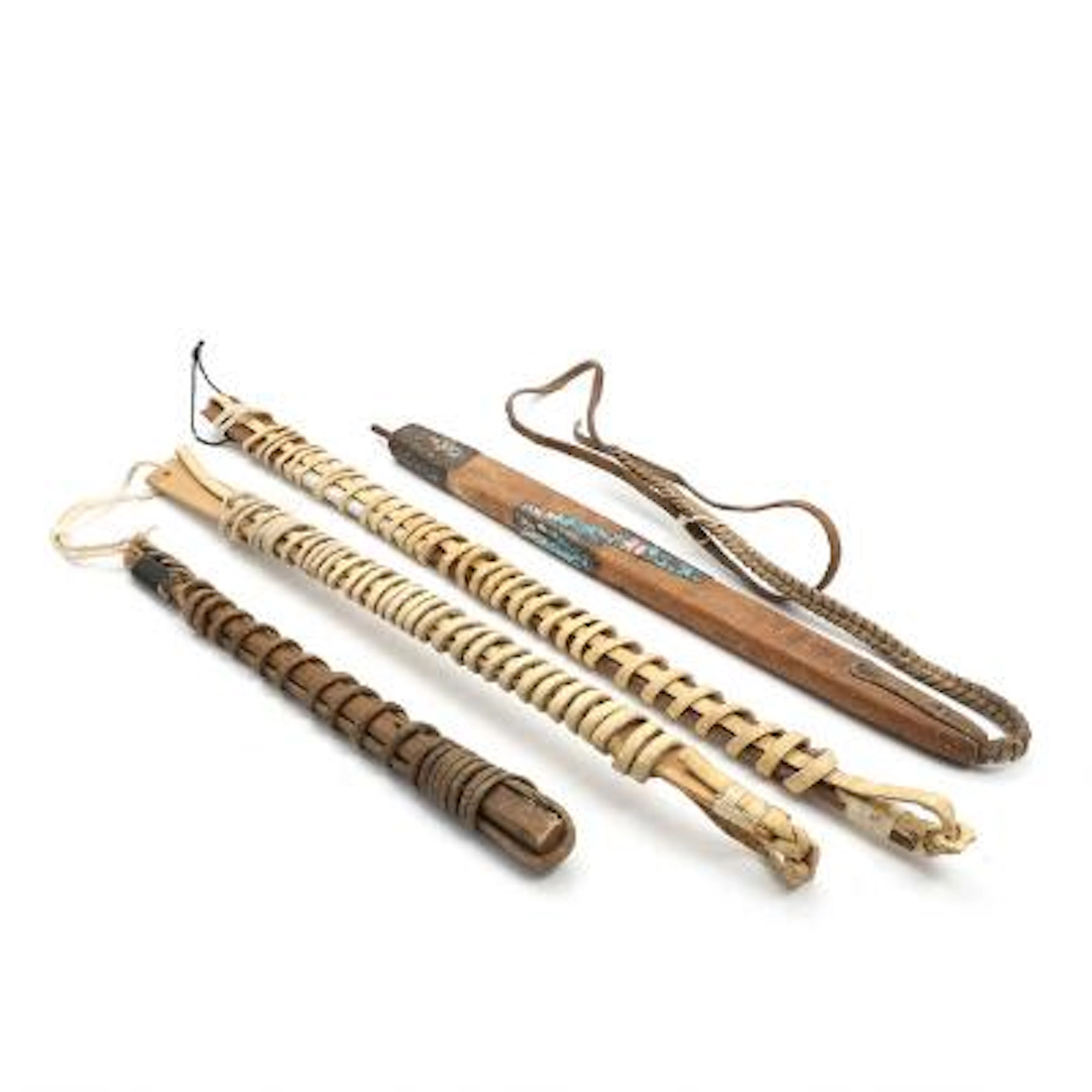 Four dog whips of wood and leather with bone and metal fittings. 20th