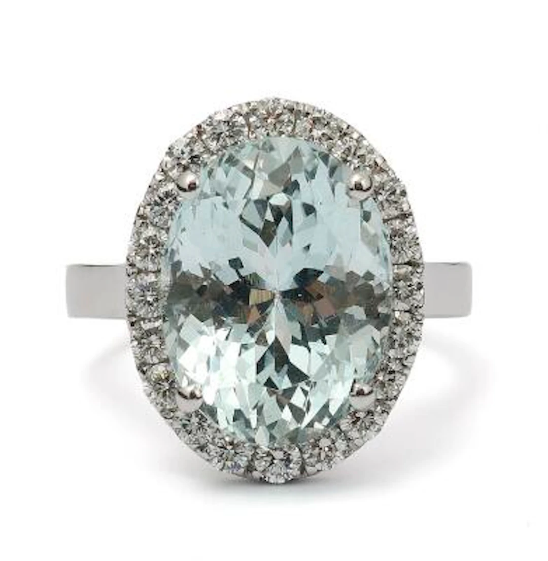 An aquamarine and diamond ring set with an aquamarine encircled by