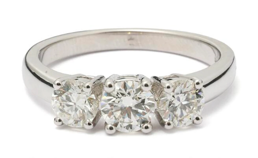 A diamond ring set with three diamonds mounted in 18k white gold.