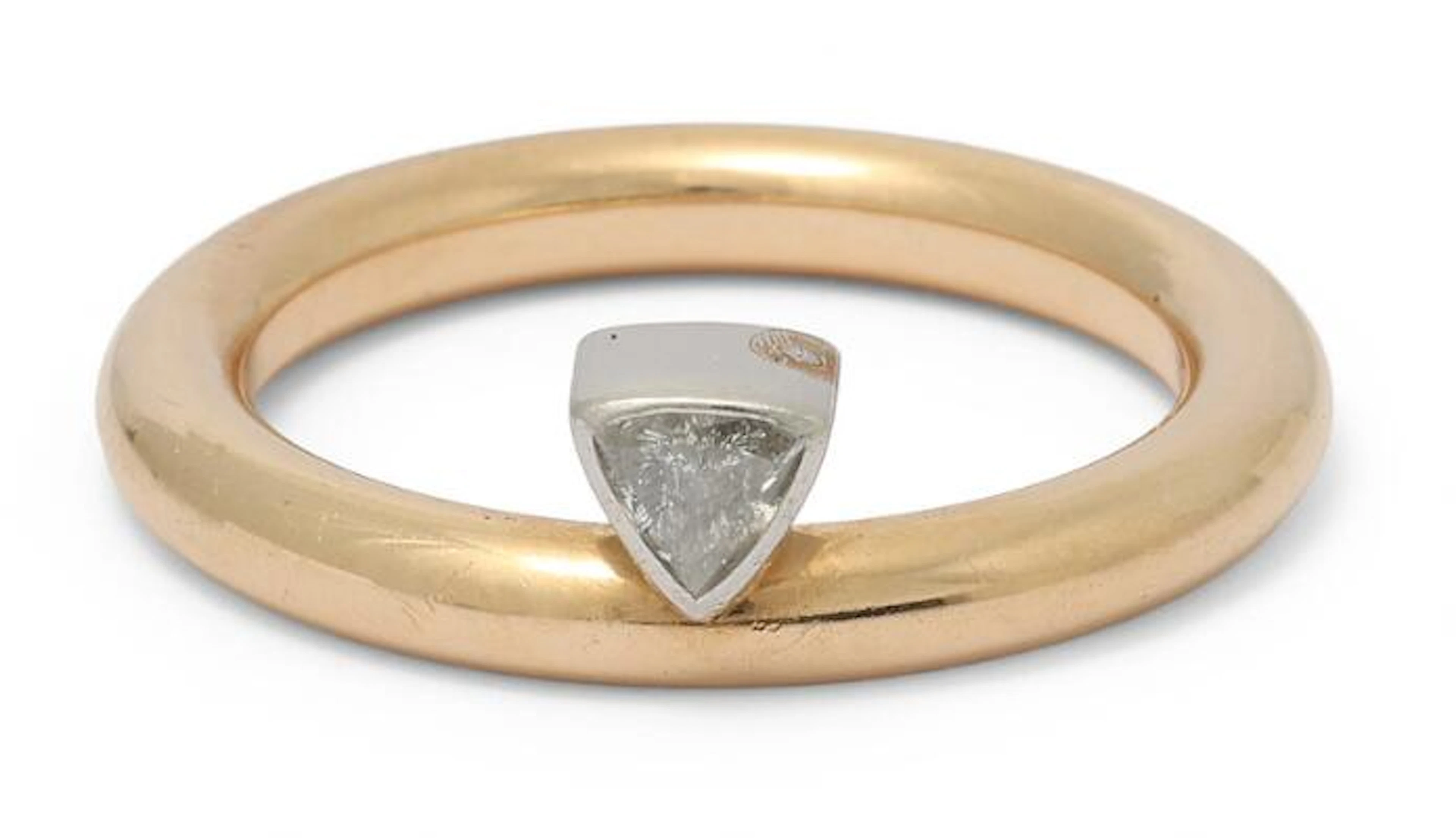 A diamond ring set with a trilliant-cut diamond, mounted in 14k gold