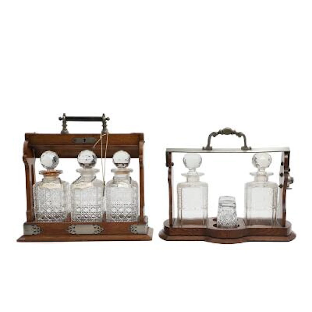 Two oak tantalus cabinets containing crystal glass decanters. Early