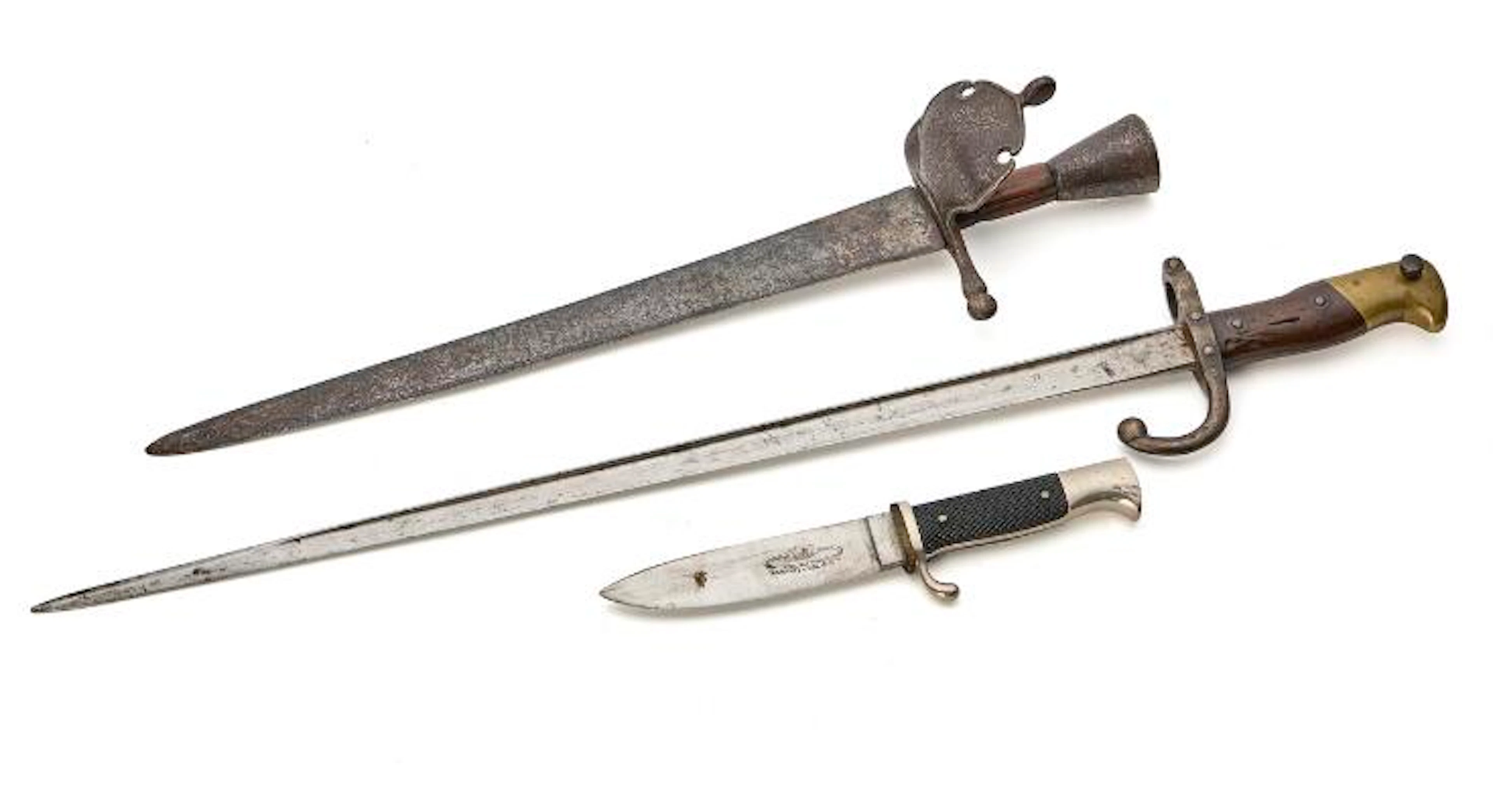 A left-hand dagger, a French bayonet, and a Scout knife. – Bruun Rasmussen