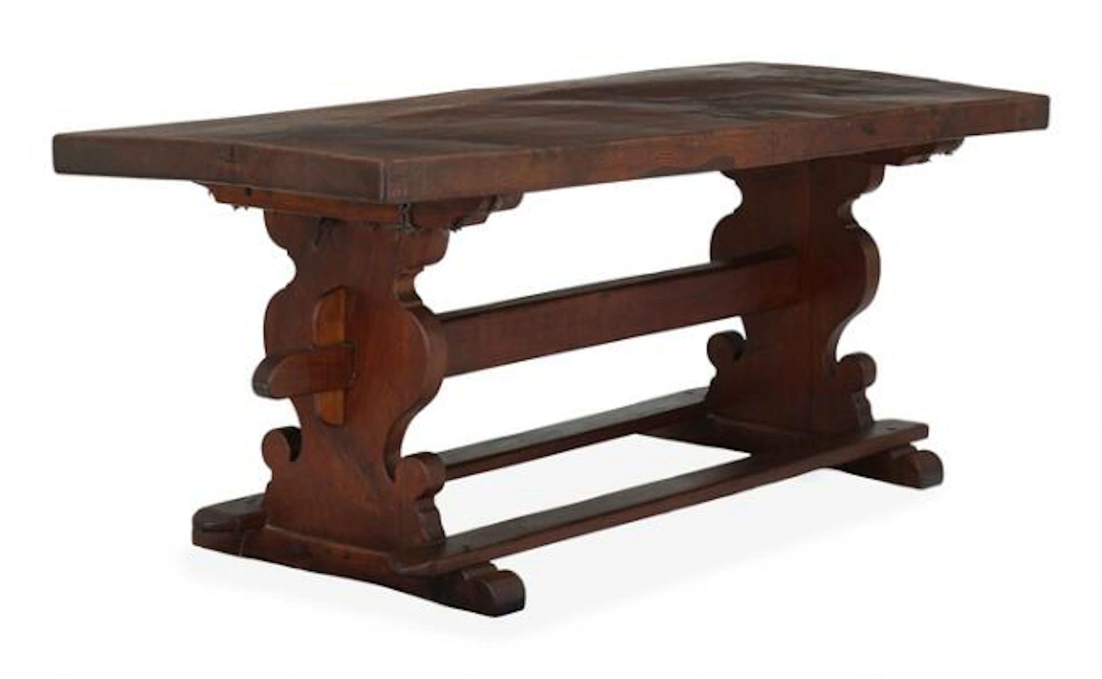 A Rustic farmers table of dark-polished oak, with profiled side panels