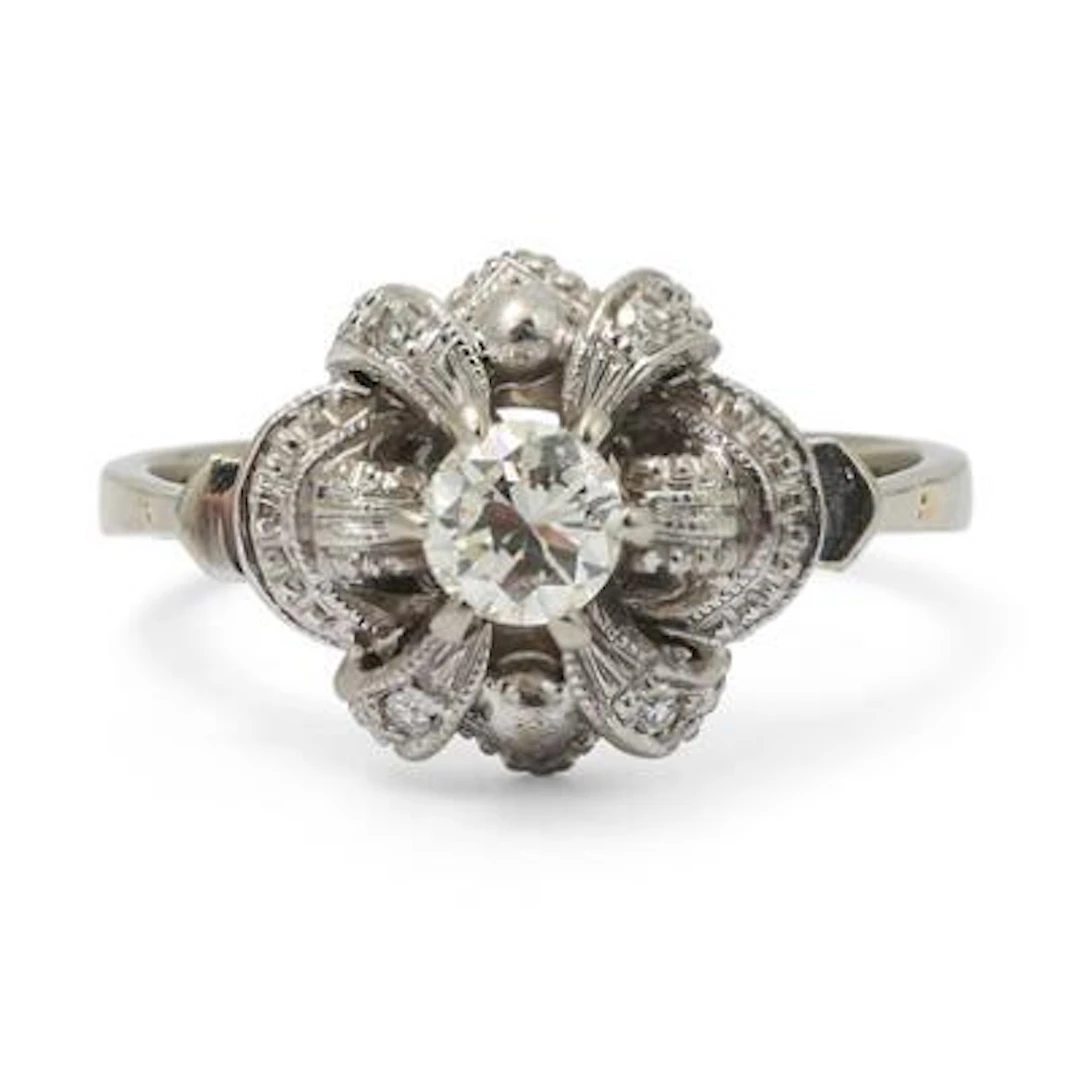 A diamond ring set with a brilliant-cut diamond and single-cut diamonds