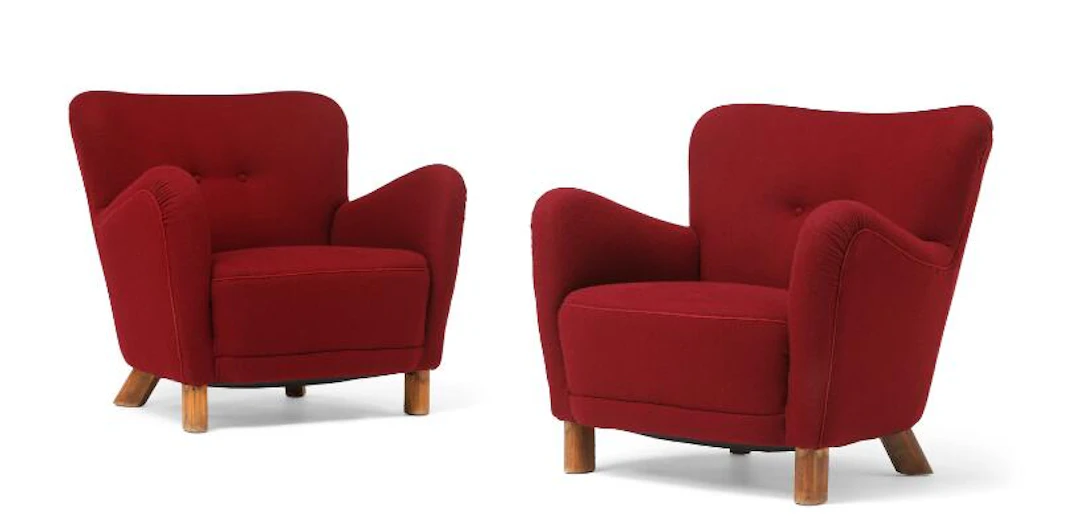 Fritz Hansen: A pair of easy chairs with oval, stained beech legs.