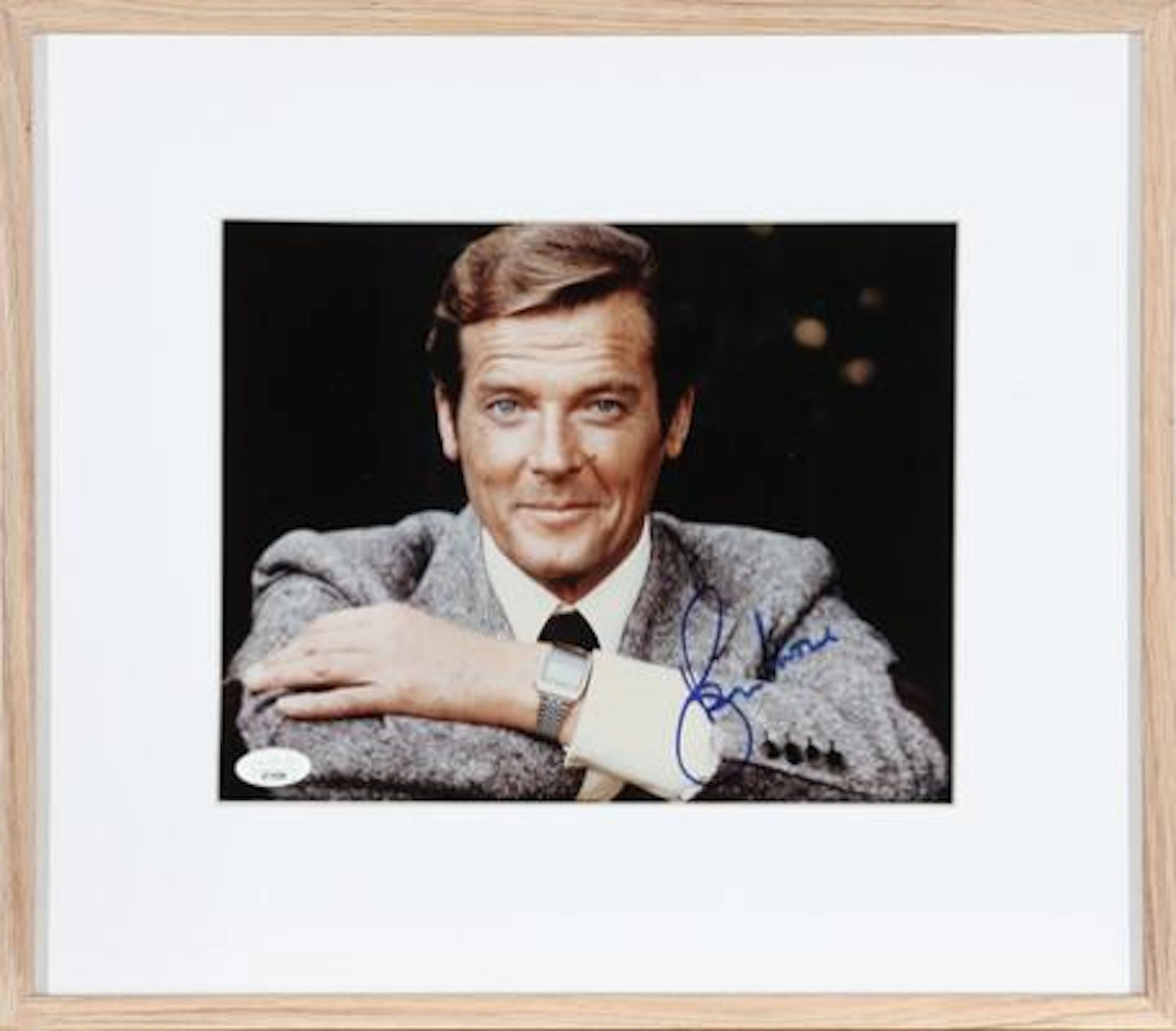 Signed colour photograph of English actor Roger Moore (1927–2017).