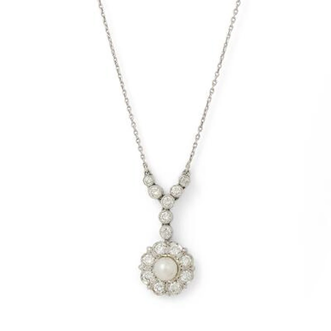 A pearl and diamond necklace set with numerous diamonds, mounted in