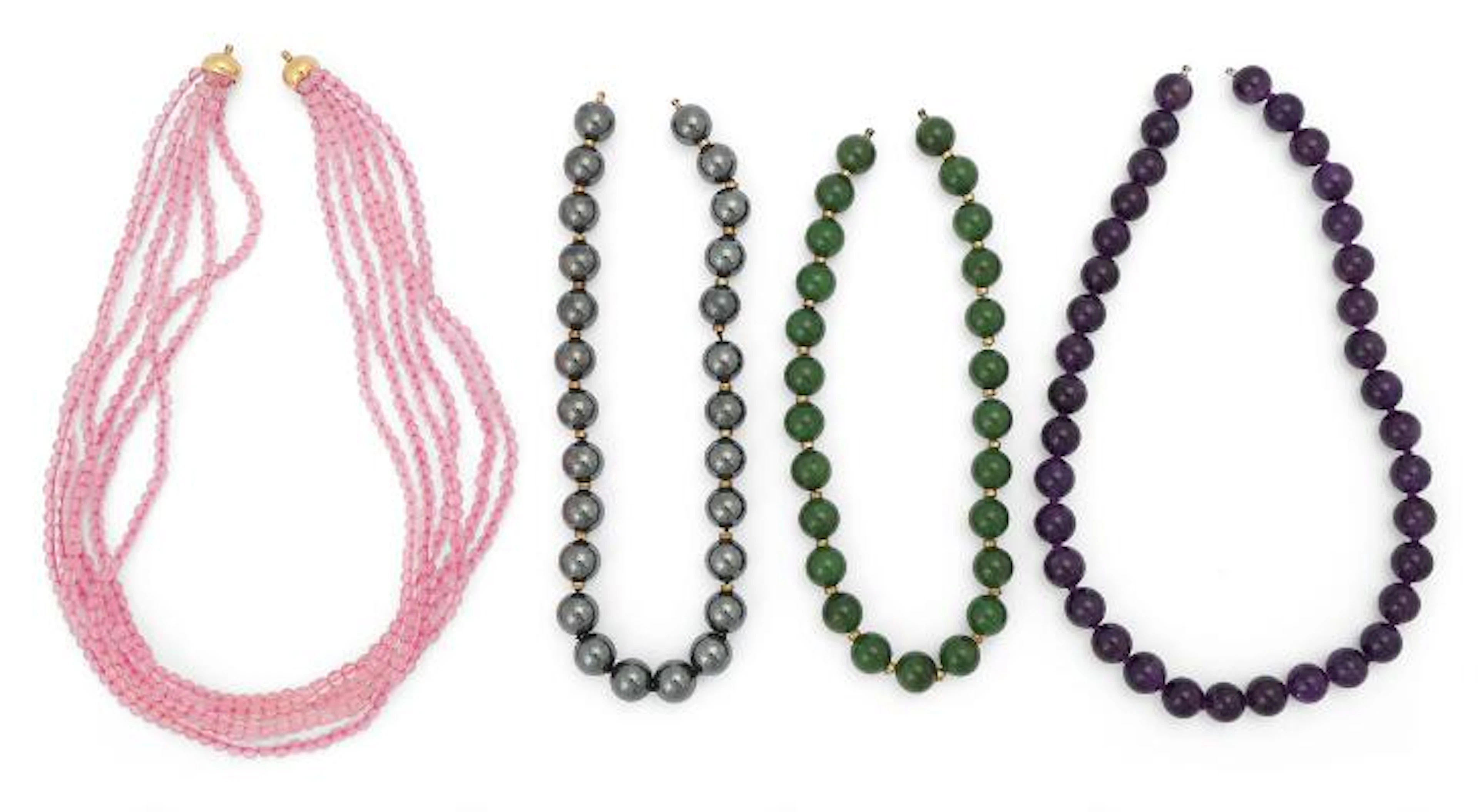 A collection of necklaces comprising polished aventurines, amethysts