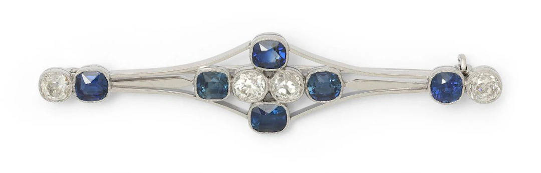 A sapphire and diamond brooch set with six sapphires and four diamonds