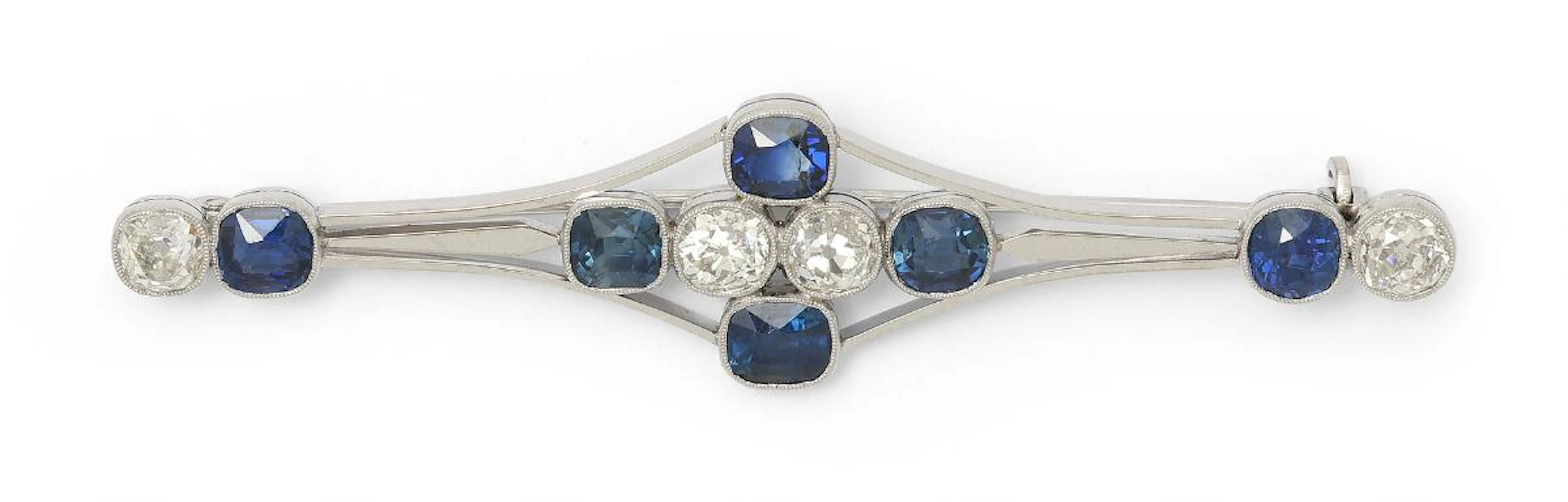 A sapphire and diamond brooch set with six sapphires and four diamonds
