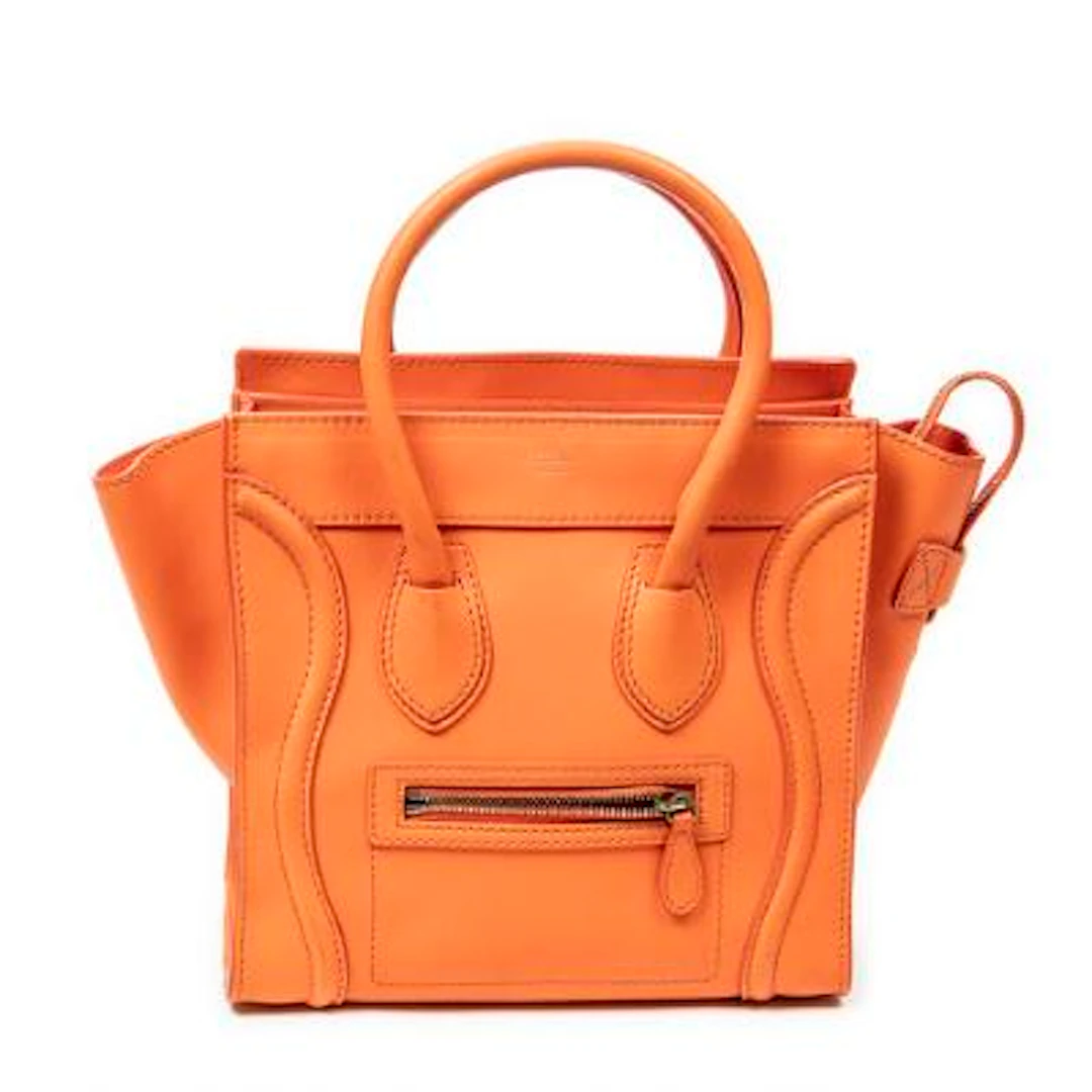 Celine: A "Micro Luggage" bag in orange leather with gold-tone hardware